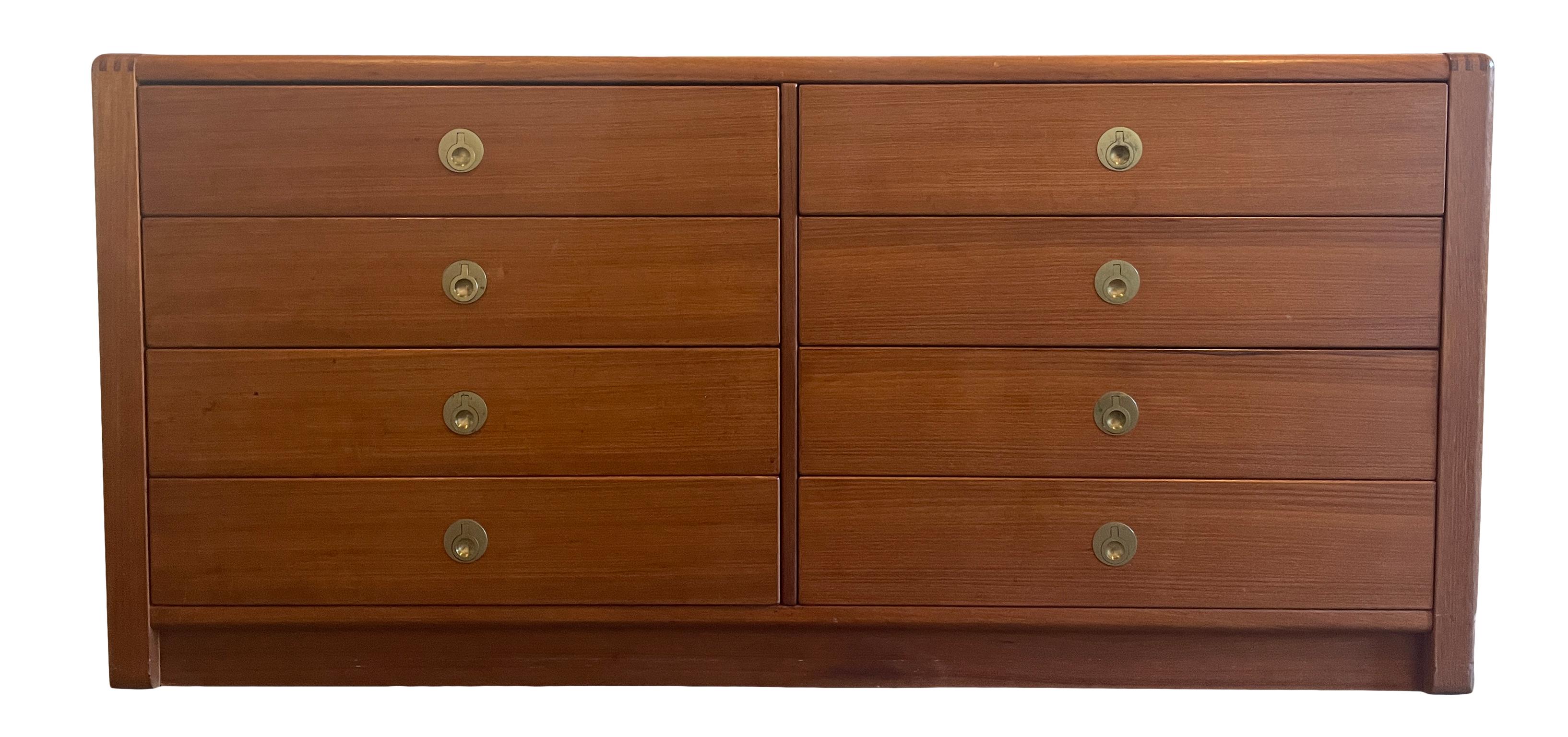 Mid-Century Modern teak tall 8 drawer low dresser brass finger pulls. Very nice construction all drawers are clean inside and out and slide smooth. Very unique brass finger pulls. Located in Brooklyn NYC.