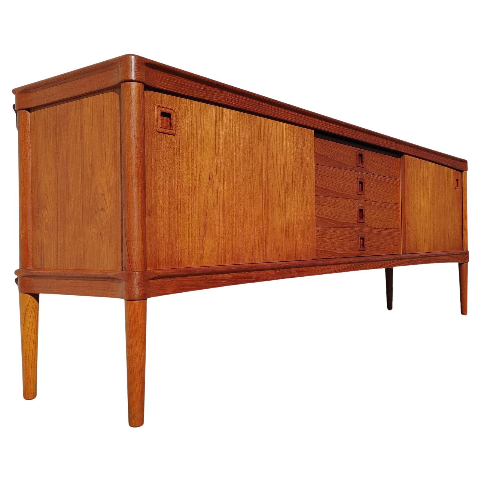 Mid Century Danish Modern Teak Sideboard by Bramin

Above average vintage condition and structurally sound. Has some expected slight finish wear and scratching. Outdoor listing pictures might appear slightly darker or more red than the item does