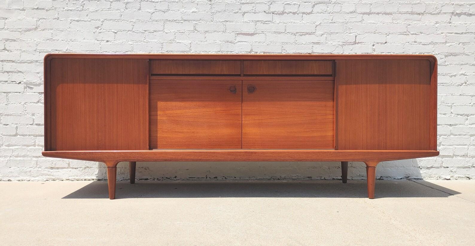 Mid Century Danish Modern Teak Sideboard by Clausen & Sons
 
Above average vintage condition and structurally sound. Has some expected slight finish wear and scratching. Beautifully crafted. Outdoor listing pictures might appear slightly darker or