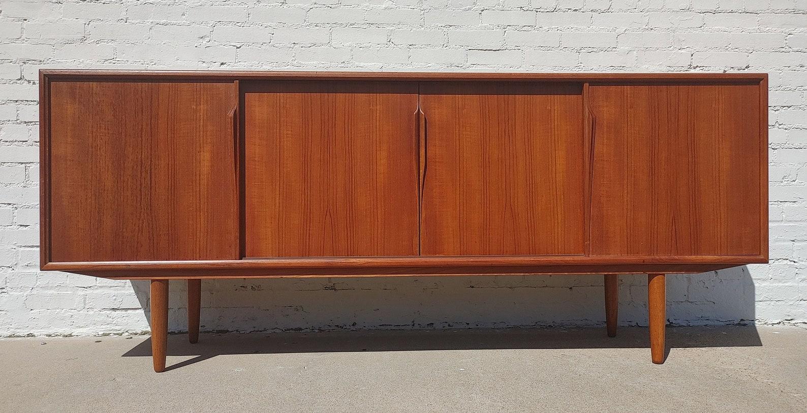 Mid Century Danish Modern Teak Sideboard by Gunni Omann

Above average vintage condition and structurally sound. Has some expected slight finish wear and scratching. Top has been refinished and does not have original factory finish. Outdoor listing