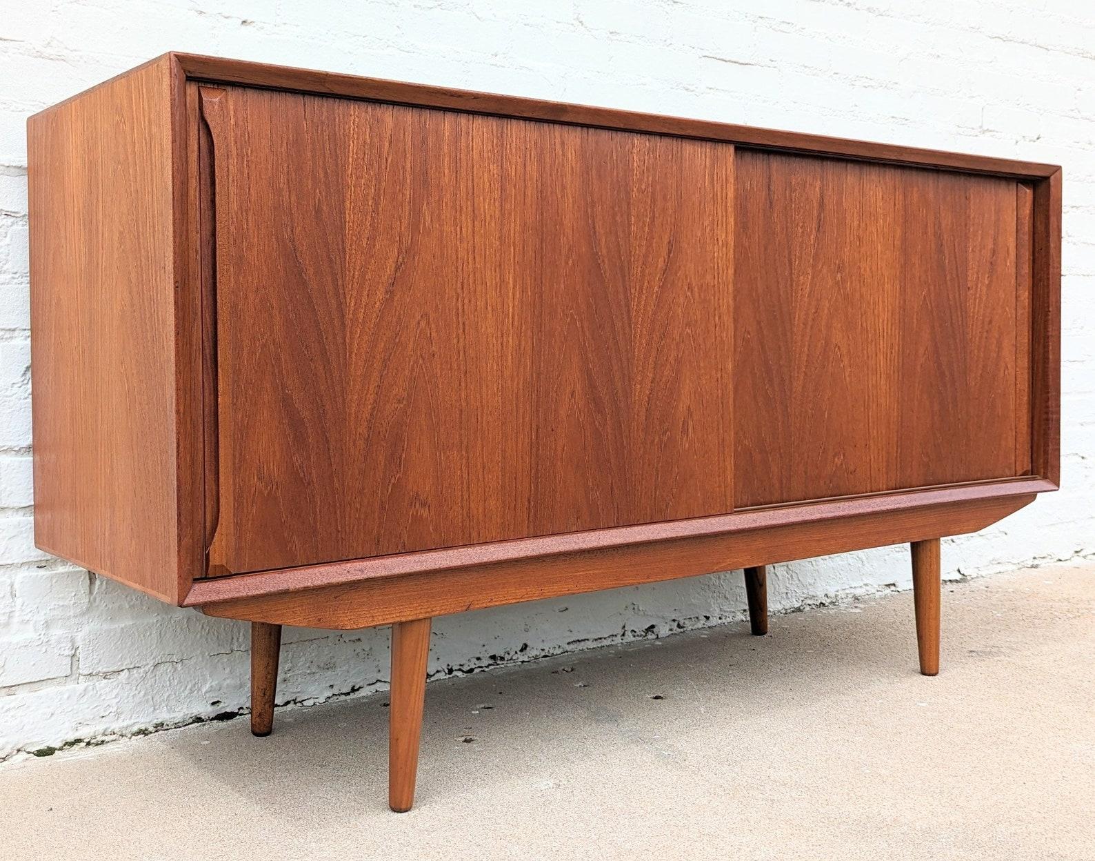 Mid Century Danish Modern Teak Sideboard

Above average vintage condition and structurally sound. Has some expected slight finish wear and scratching. Has a couple small dings and discolorations on top and edges. Top has been refinished and does not