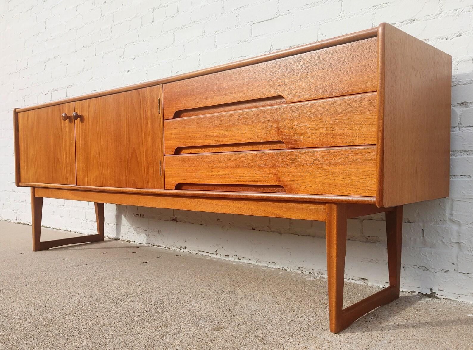 Mid Century Danish Modern Teak Sideboard

Above average vintage condition and structurally sound. Has some expected slight finish wear and scratching. Outdoor listing pictures might appear slightly darker or more red than the item does indoors.