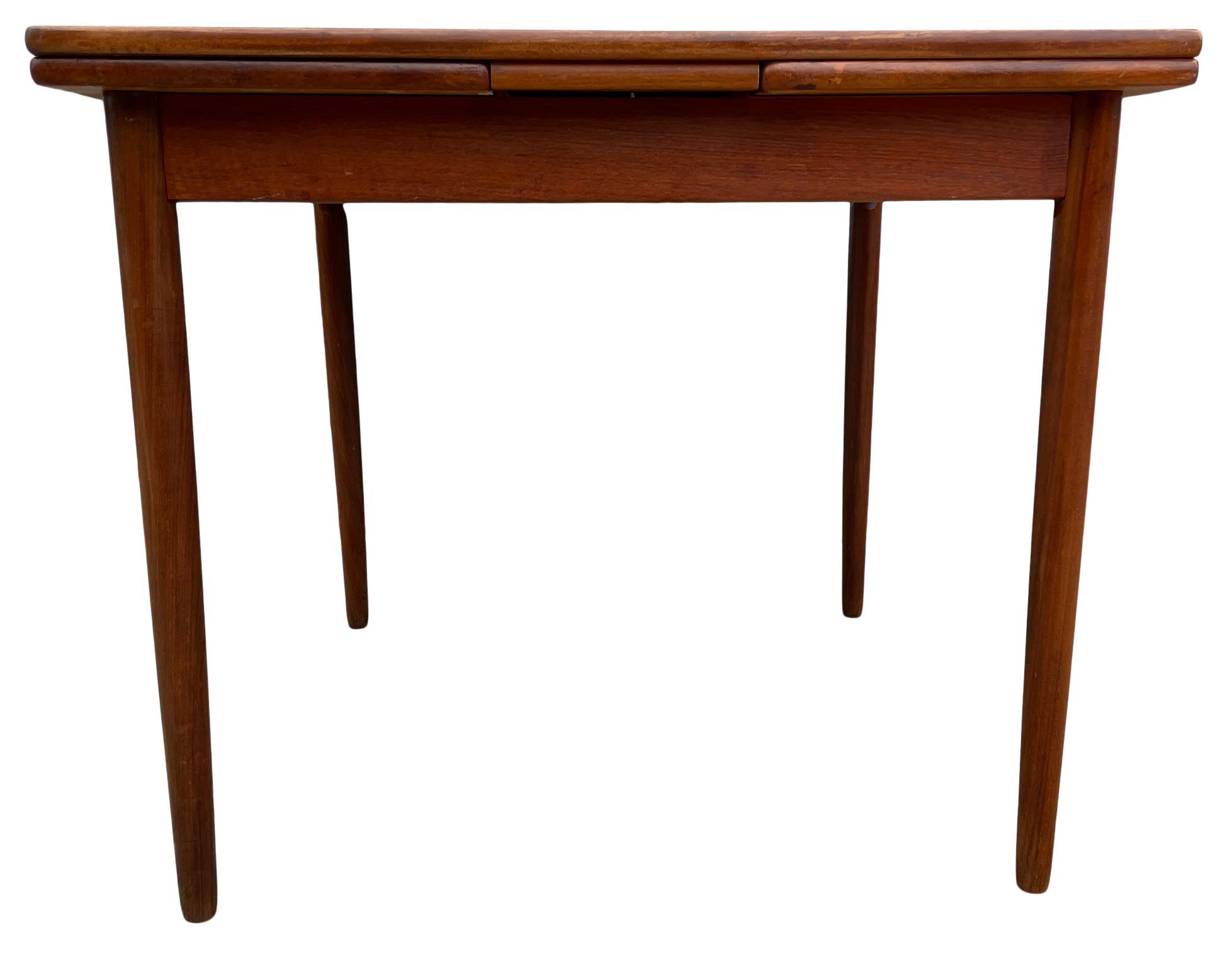Mid century Danish modern teak small refectory extension dining table. Made in Denmark 
Great vintage condition - All Legs unbolt. Great for small spaces.

Table is square 33