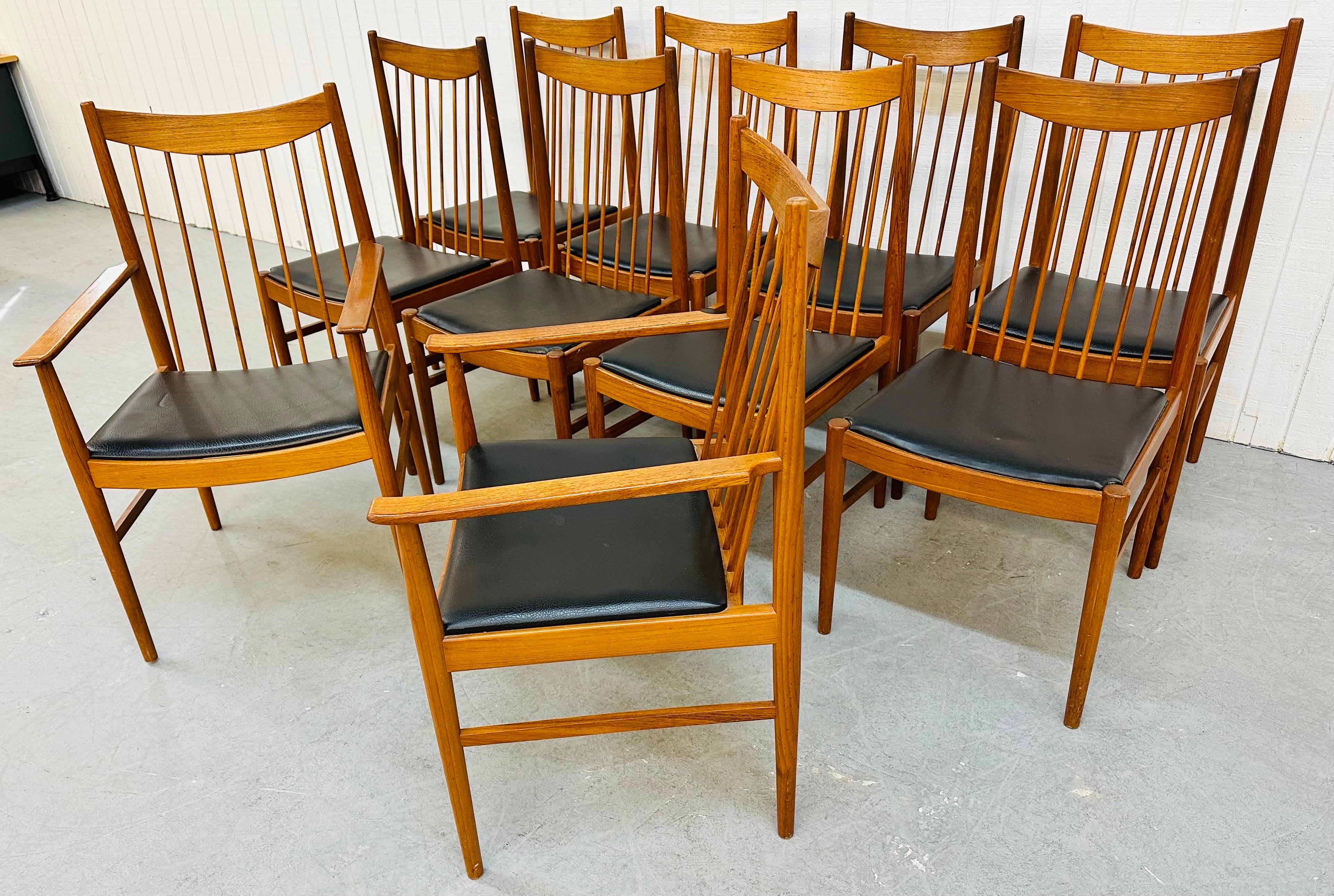 This listing is for a set of eight Mid-Century Danish Modern Teak Spindle Dining Chairs. Featuring eight straight chairs, two arm chairs, spindle backs, original black vinyl upholstery, curved back rest tops, and a beautiful teak finish.
