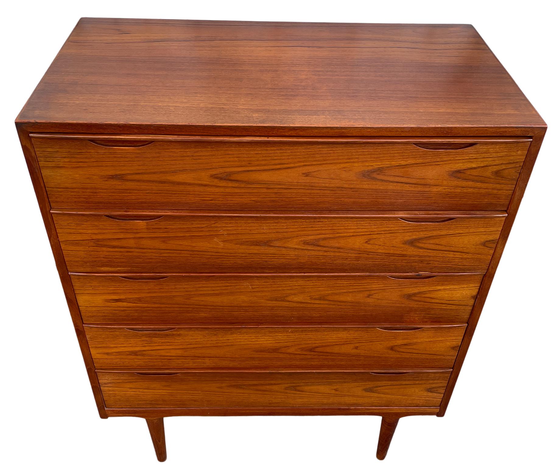 Mid Century Danish modern teak tall dresser by Arne Vodder denmark. Beautiful carved handles tall 5 drawer danish dresser. Amazing construction and quality woodwork. Stunning teak wood grain. Labeled on back. Located in Brooklyn NYC.