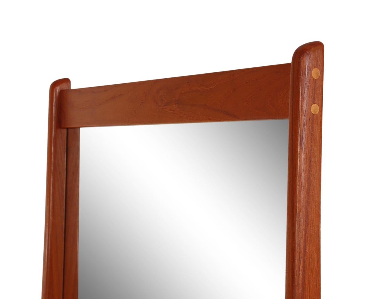 A beautifully designed and constructed wall mirror made Jansen Spejle in Denmark. It consists of solid teak construction with beautiful detailed workmanship.