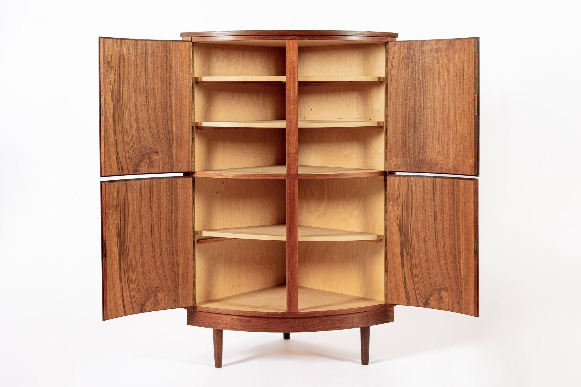 This exceptional vintage mid century Danish modern teak corner cabinet was made in Denmark circa 1960. The classic Scandinavian design has clean, elegant lines and is well-crafted from teak wood with beautiful natural grain. This unique cabinet