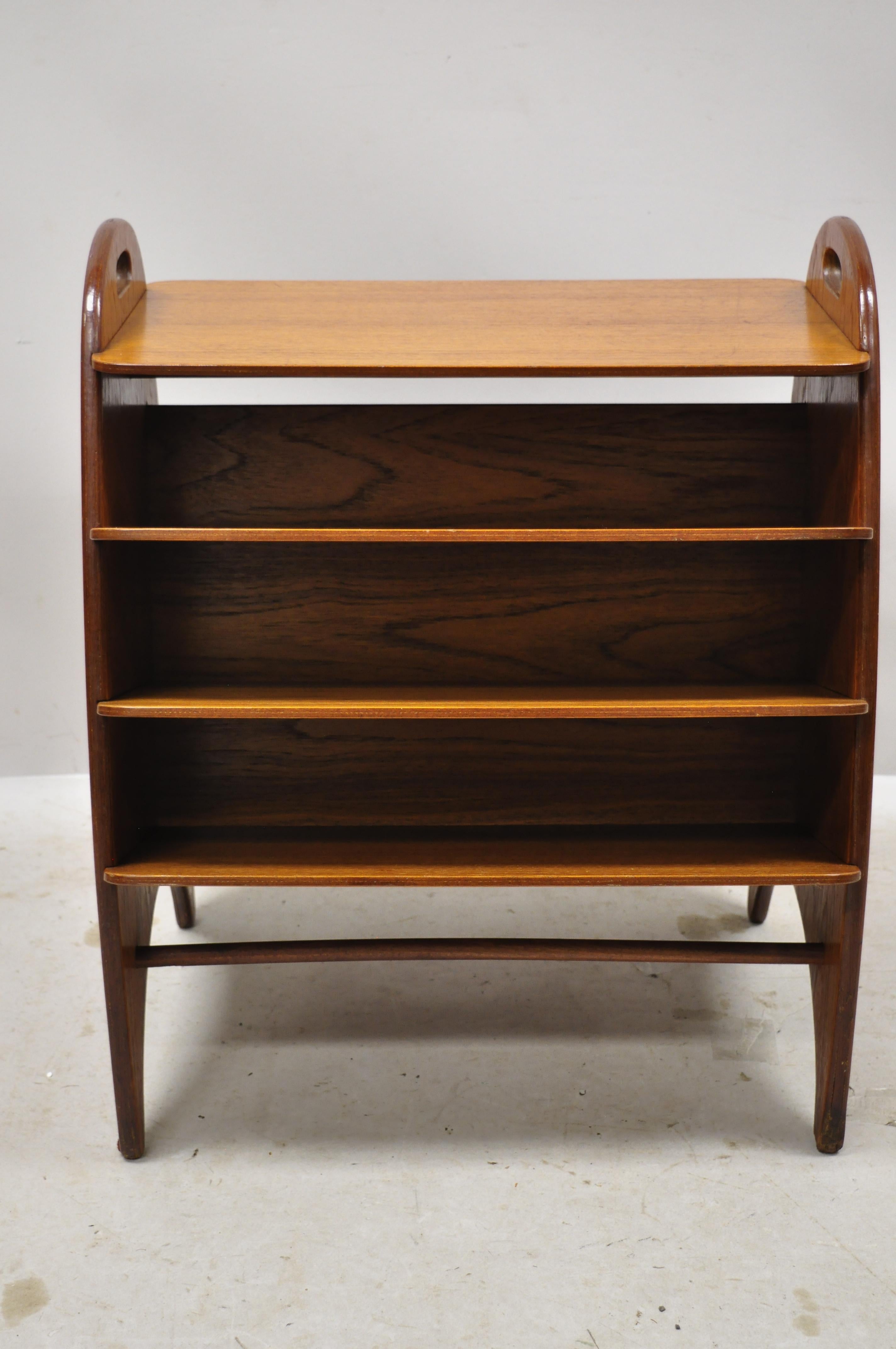 midcentury Danish modern teak wood magazine rack book stand bookcase side table. Item features beautiful wood grain, wooden shelves, very nice vintage item, sleek sculptural form, circa mid-20th century. Measurements: 24