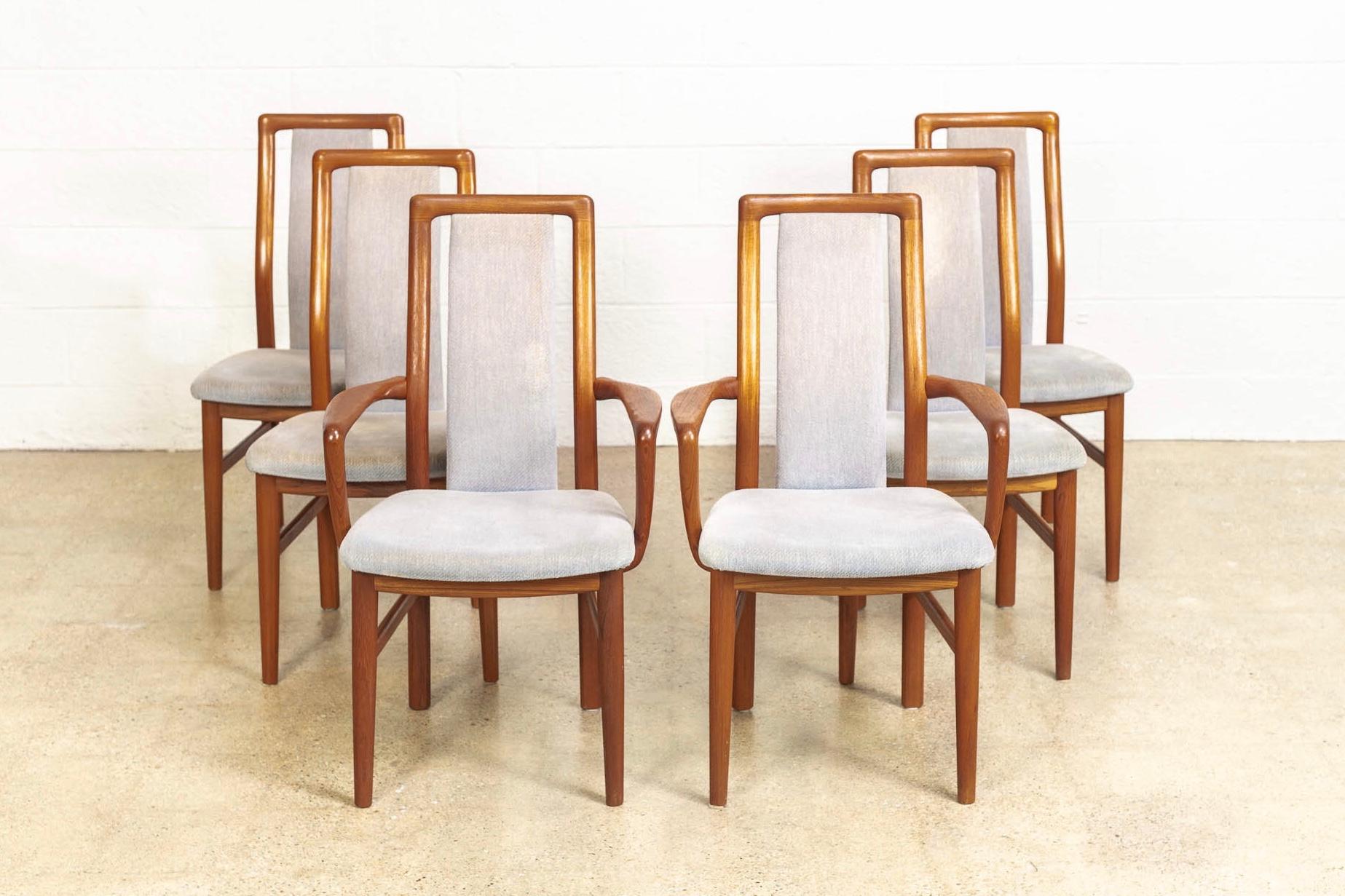 This set of 6 vintage Mid-century Danish modern dining chairs are circa 1960. The Classic Danish modern design features clean lines and elegant curves. The chair frames are made of solid teak wood and feature high backs and a beautiful sculpted