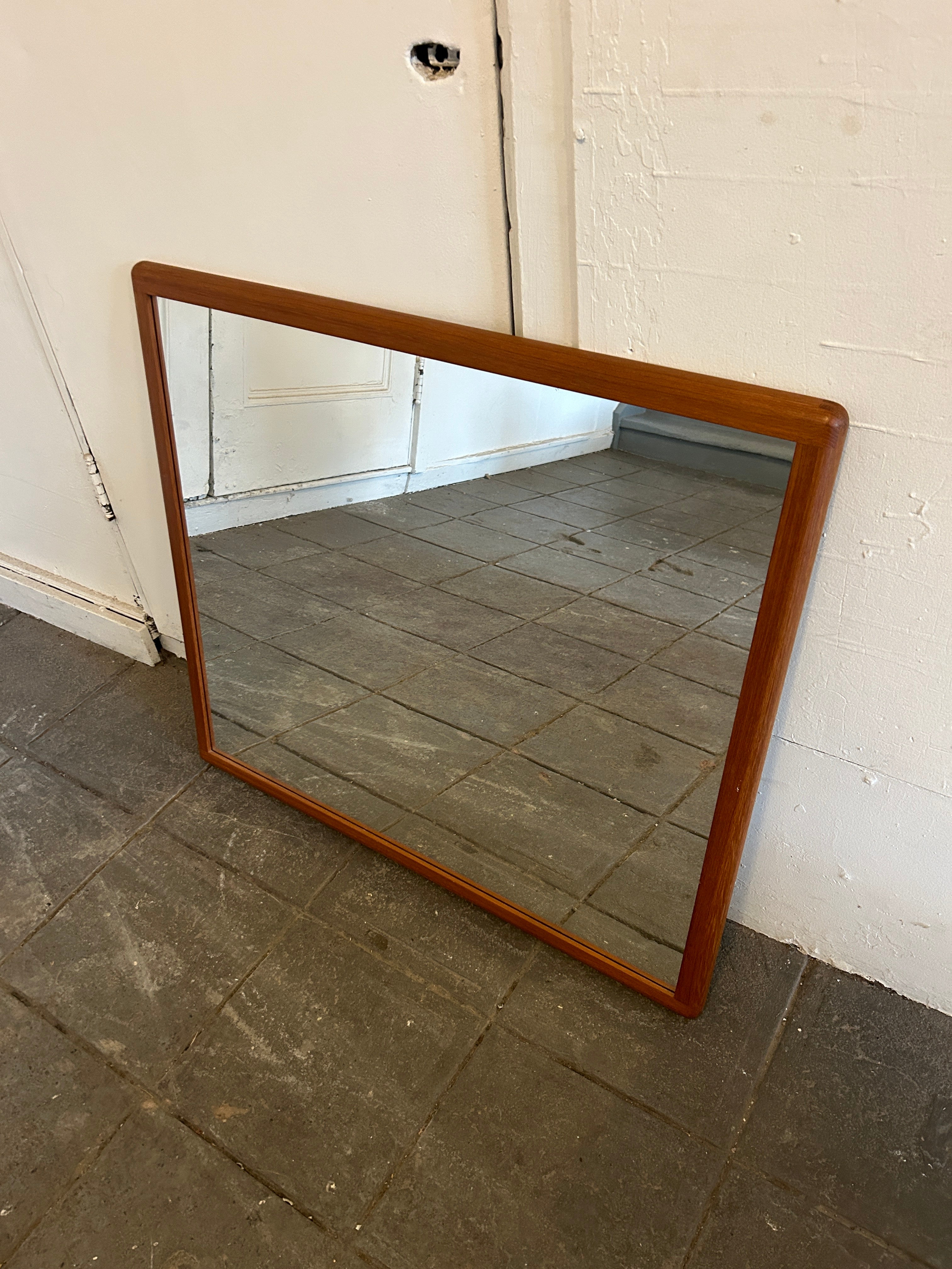 Wonderful Scandinavian Danish modern teak wood mirror. Wired to hang horizontal. Very solid mirror with solid teak wood frame.

 31” x 35” x 1” deep.

 