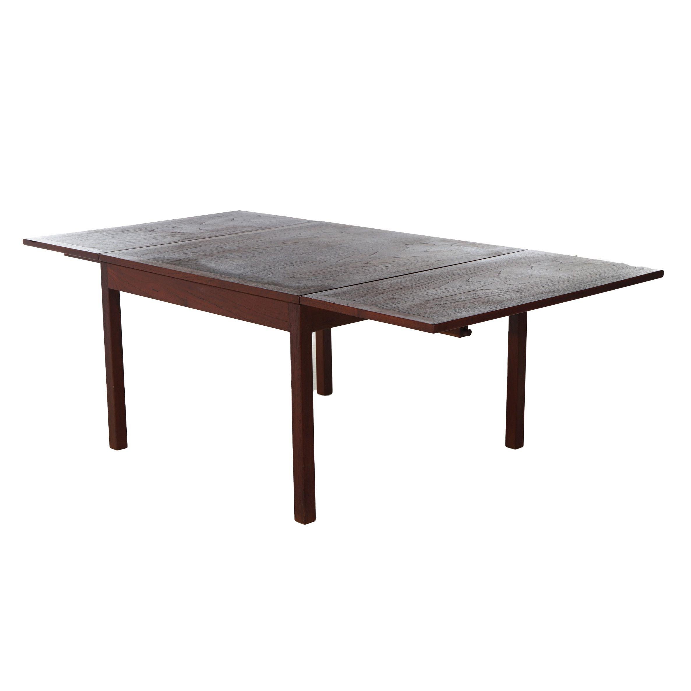 A Mid Century Danish Modern low table offers teak construction with drop leaves and raised on square straight legs, c1960

Measures - 21.25