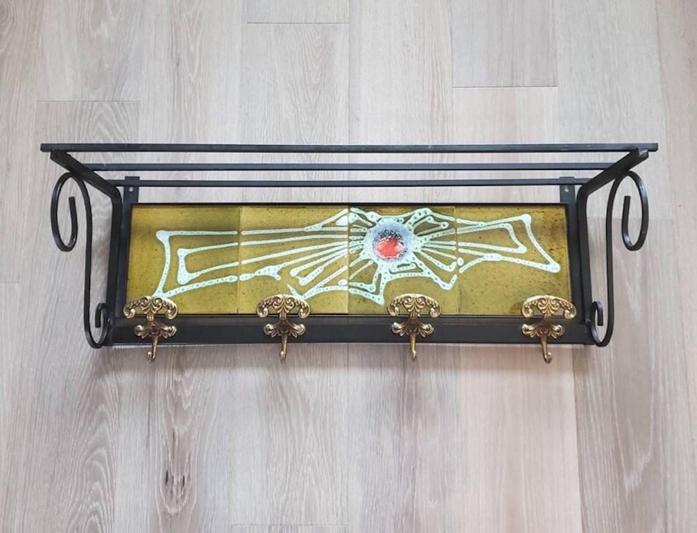 An exceptional Danish modernist tiled wall rack. The focal point of this stunning vintage designer piece, a set of four magnificently polychrome decorated hand painted, abstract design, geometric motif, glazed ceramic art tiles by Mosa! The