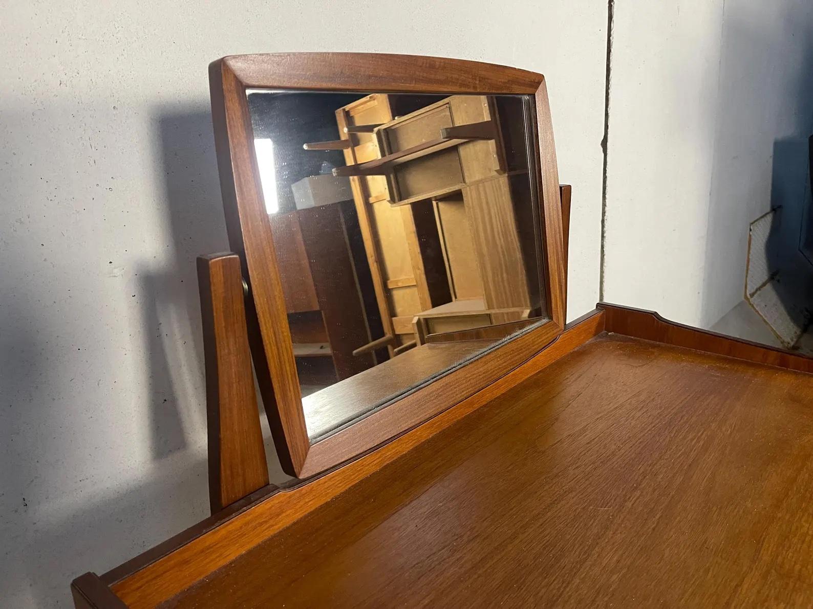 This vintage mid-century Danish modern vanity desk table is a stunning addition to any space. The table features a beautiful mirror that adds depth and dimension to the piece. Crafted in Denmark, the table showcases a Scandinavian design that is