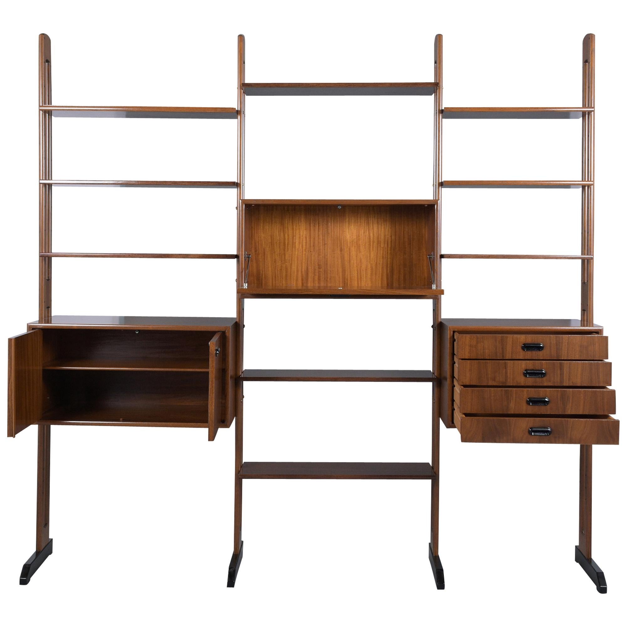 An extraordinary Mid-Century Danish modern bookcase hand-crafted out of walnut wood, fully restored and newly refinished in a dark walnut color with an ebonized finish and a lacquer finish. This beautiful bookcase features three cabinets, one of