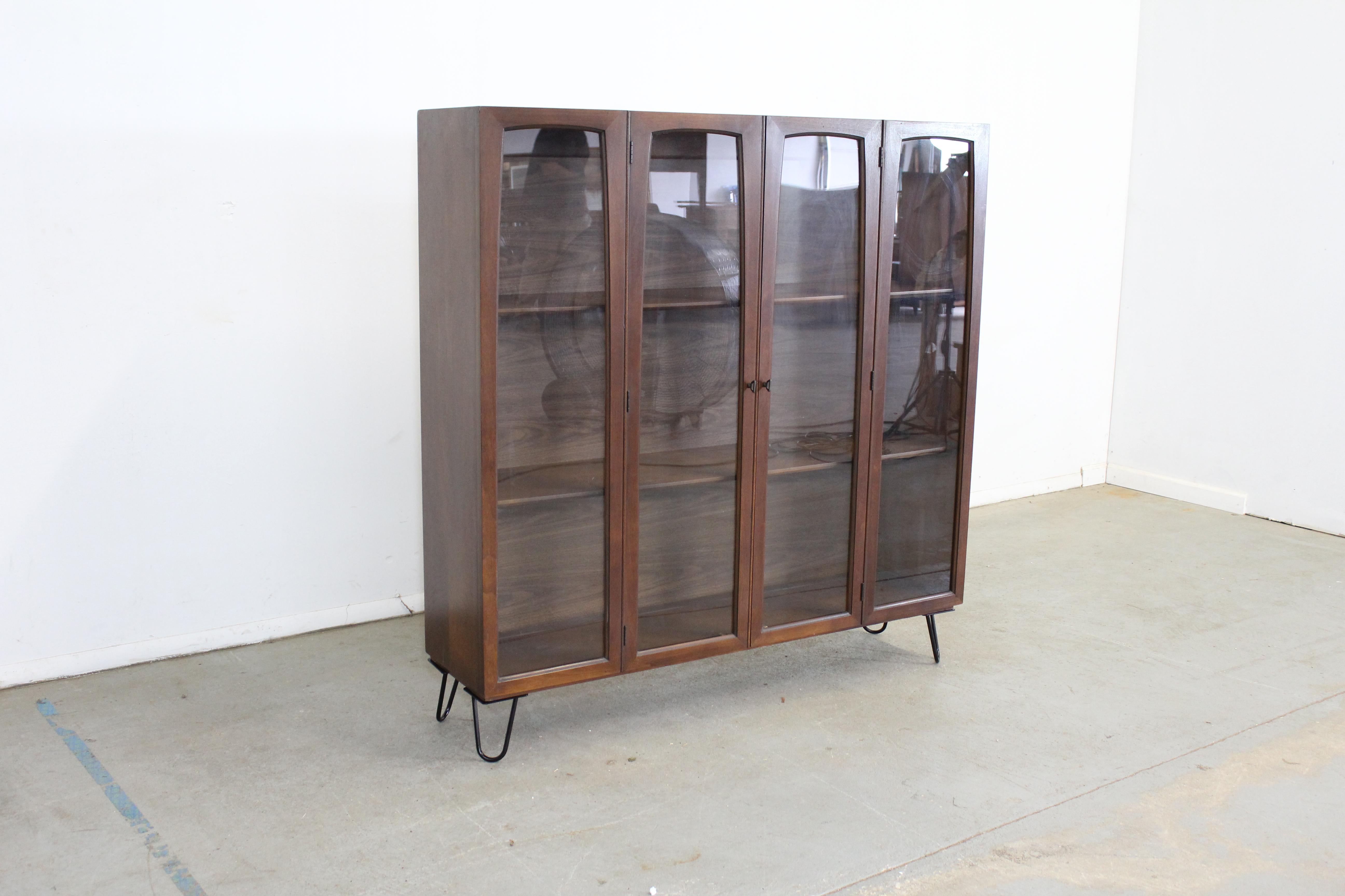 Danish modern walnut shelving unit 

Offered is a Danish modern walnut shelving unit. It has three shelving sections. It also feature two glass sliding doors that fold for efficiency. It is structurally sound with some minor fading and scratches