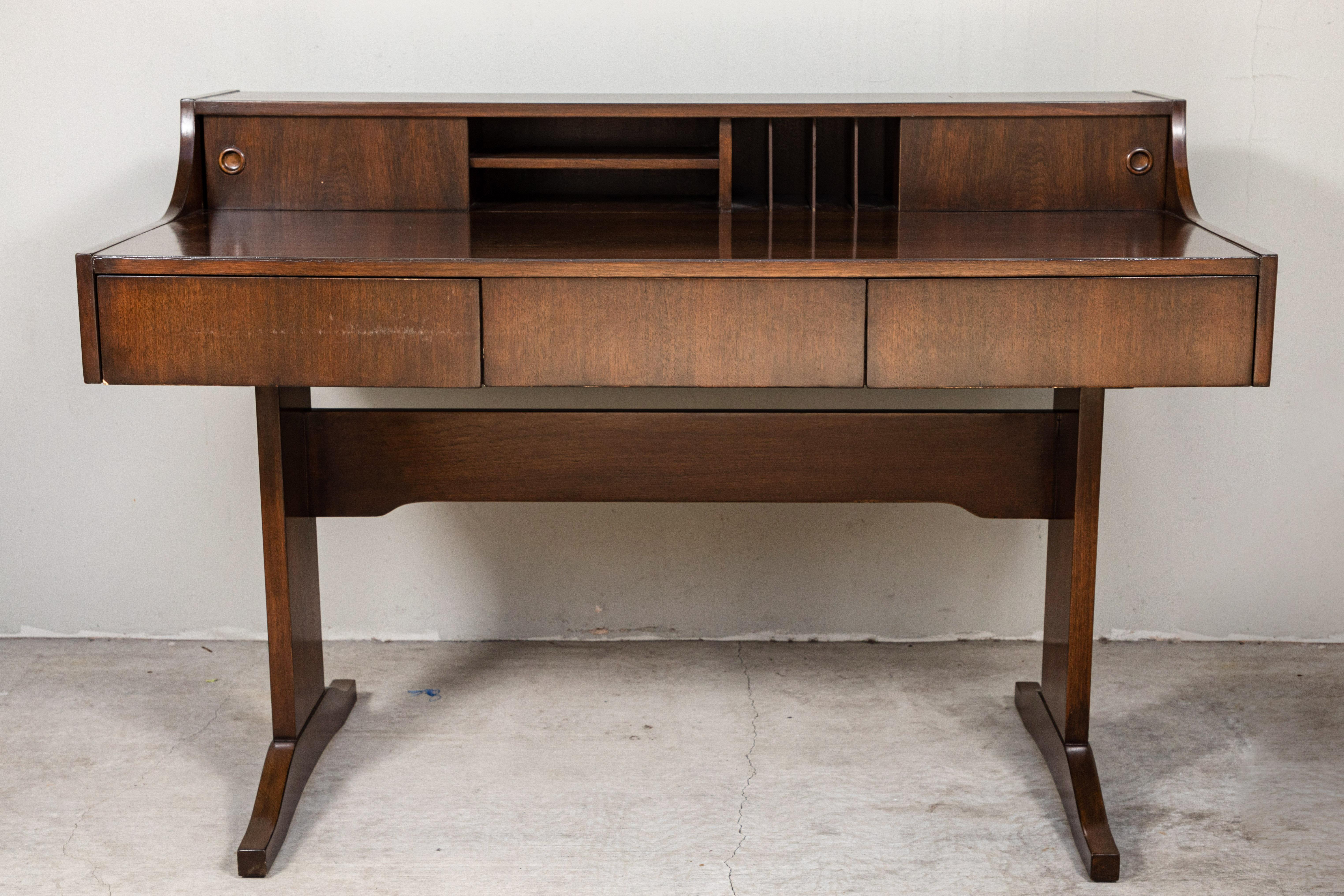 Handsome Danish modern desk, in walnut, 1960s, by Peter Lovig. Desk has three drawers across the front and multiple cubby holes in the back.
