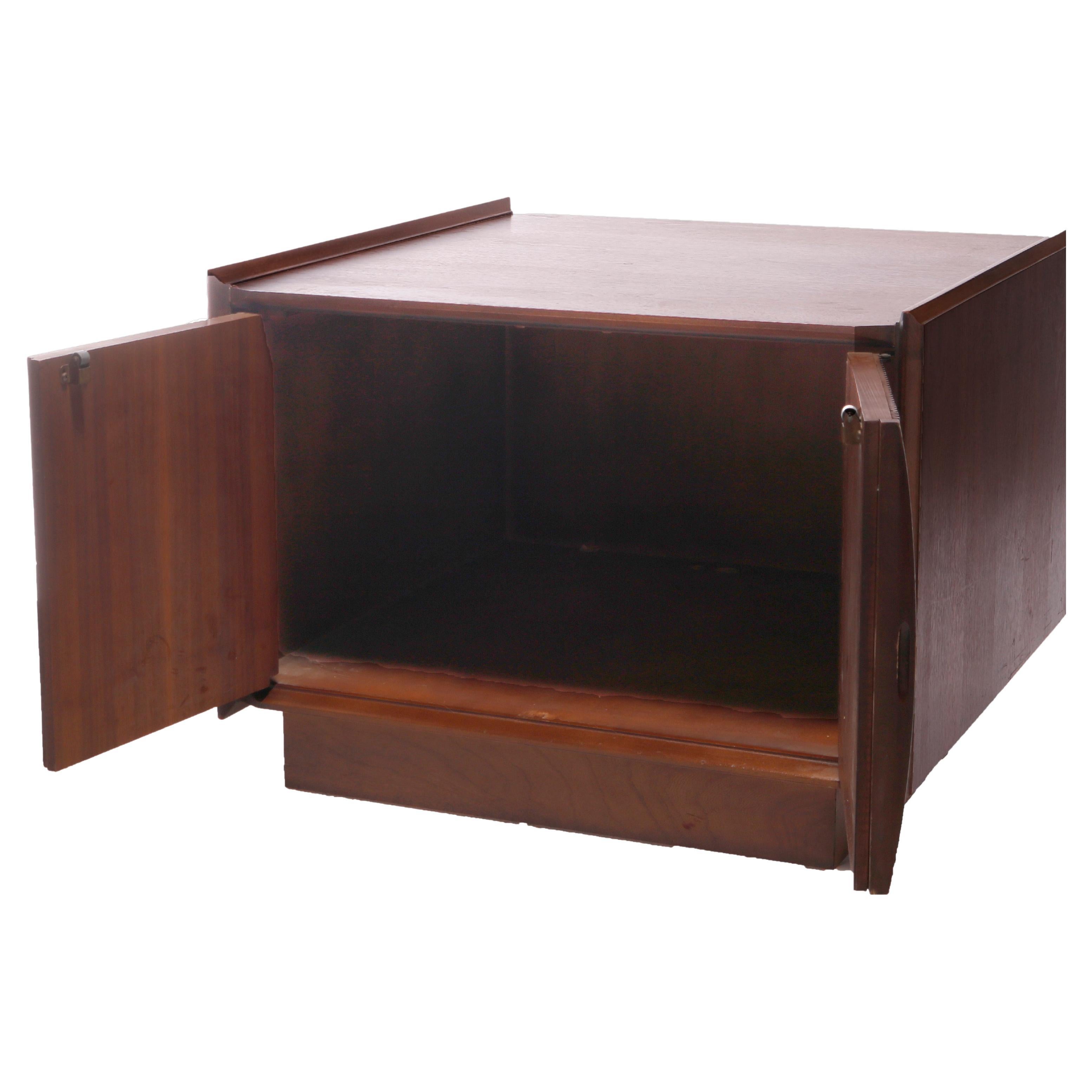 A Mid Century Danish Modern end stand offers walnut construction in cube form with double tambour style doors opening to interior storage compartment, c1960

Measures- 21''H x 28.25''W x 28''D