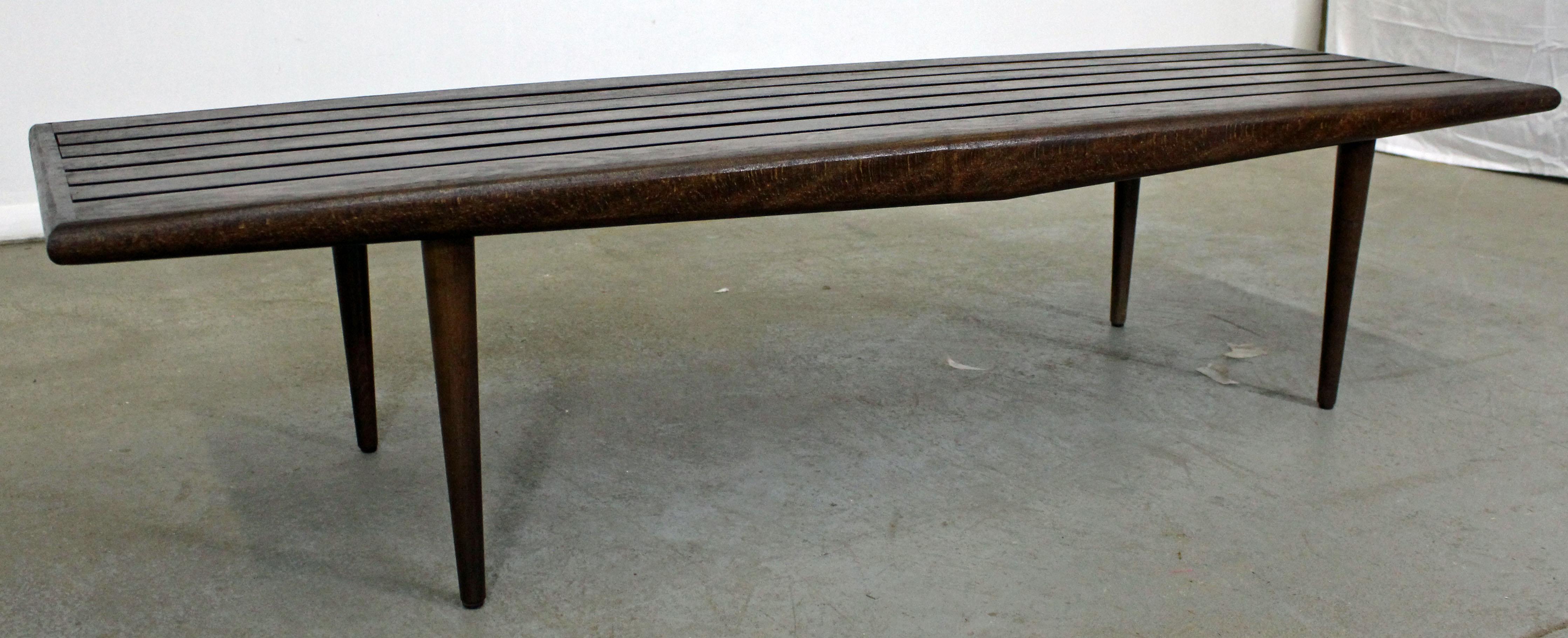Offered is a Mid-Century Modern walnut slat bench coffee table. It is in excellent condition, showing little age wear (has been refinished, minor chips/wear). It is not signed. Check out our other listings for more vintage, primitive and antique