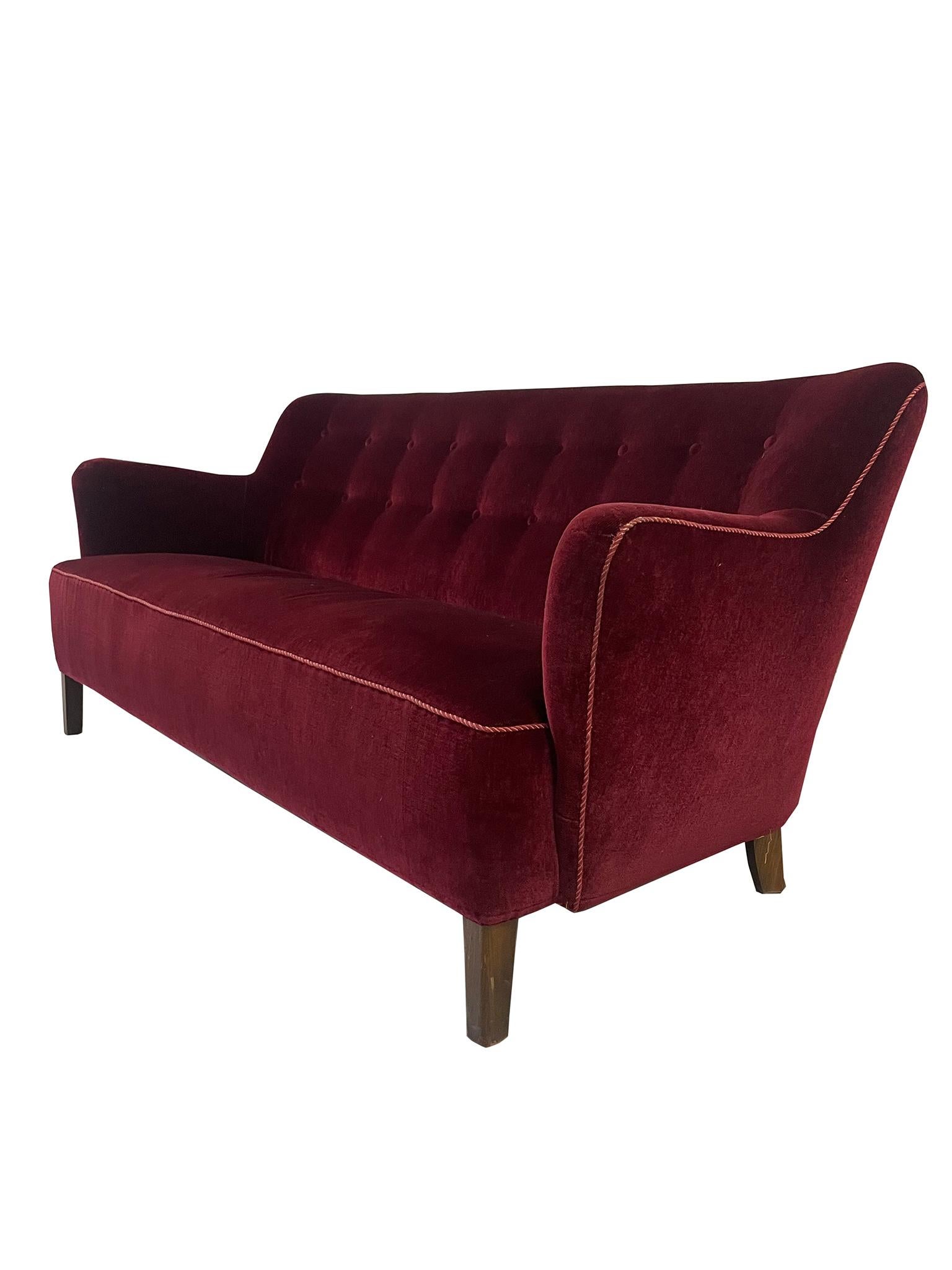 Charming Mid-Century Danish Modern Wingback Sofa by Iconic furniture maker Slagelse Møbelværk. Beechwood legs support a typical Danish winged backrest and curved arms. Further supported by coils and a deep, plush seat, this sofa is a wonderful