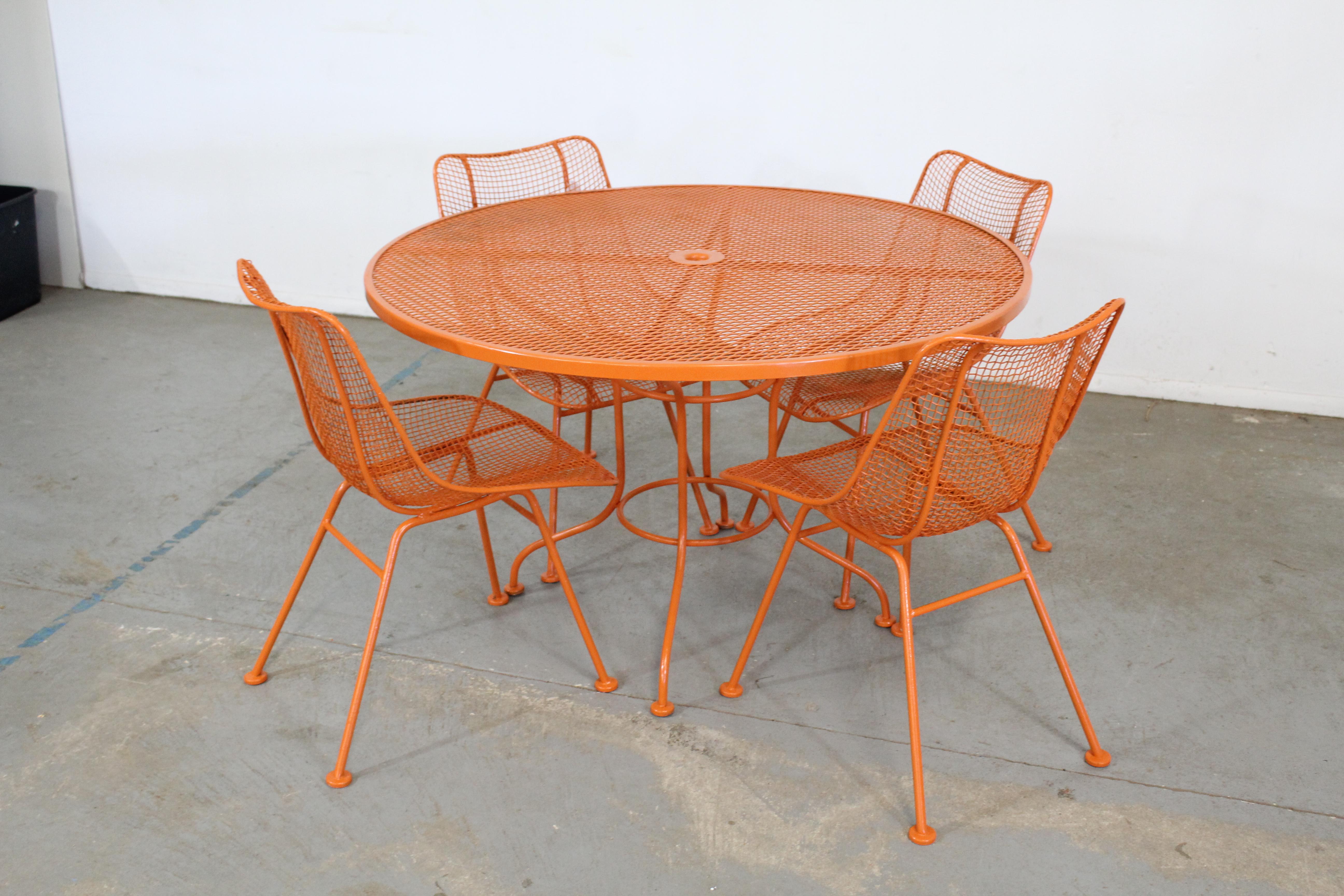 Offered is a mid century Danish Modern Woodard sculptura table and 4 side chairs designed by John Woodard, circa 1956 for the 'Sculptura' line. Features enameled and woven wrought iron. The chairs are structurally sound in very good condition with