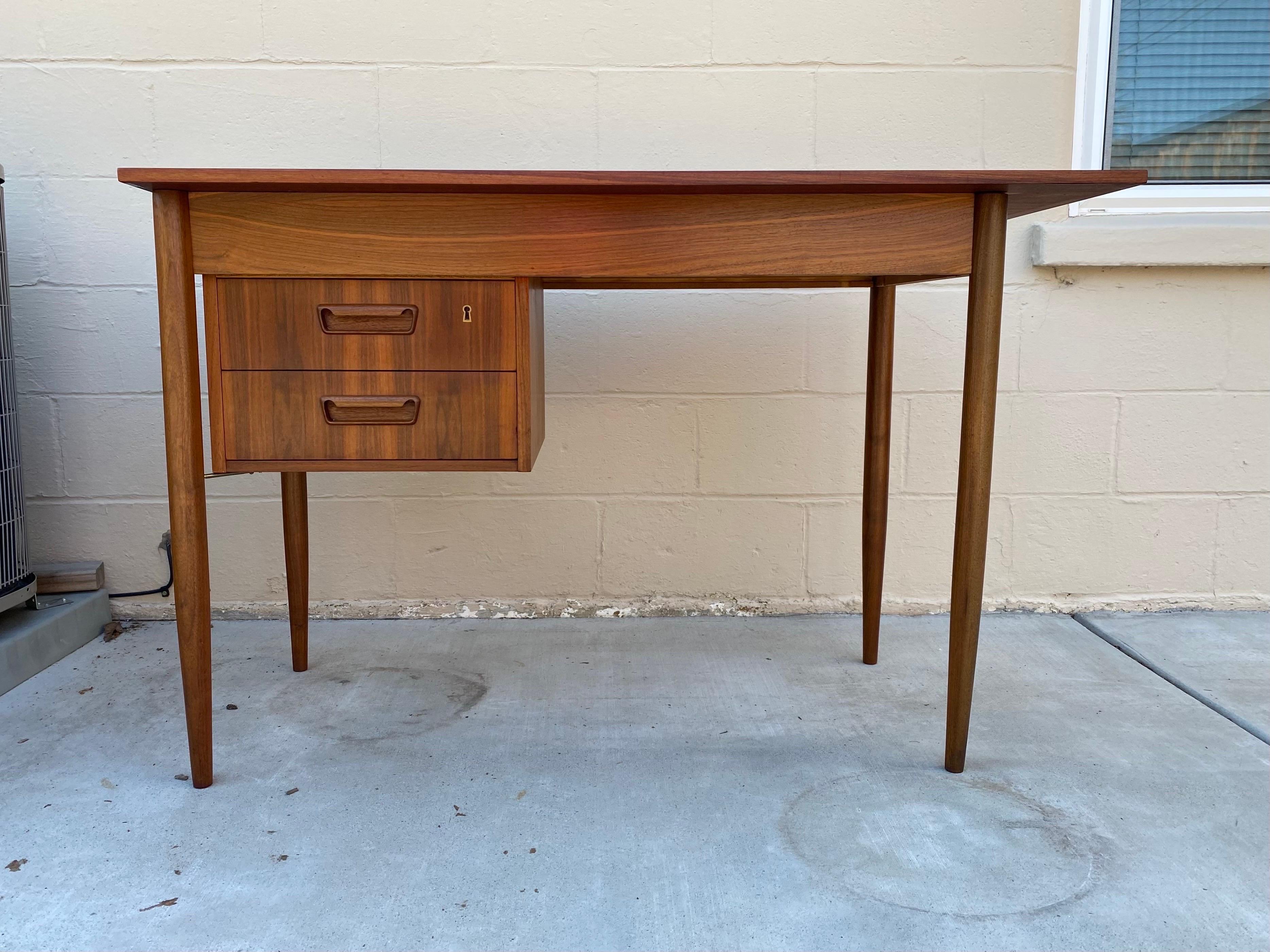 Beautiful and sleek Mid-Century Modern or Danish Modern desk in teak. This desk was designed by Gunnar Nielsen Tibergaard and Made in Denmark in the 1960s.

This vintage writing desk comes in a very useful Size that wont take up much space, but will