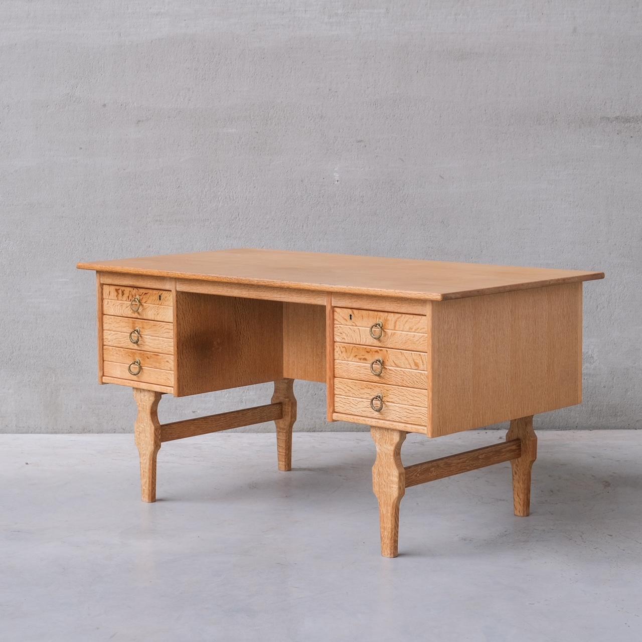 A good looking simple desk, in oak, with reverse shelf for displaying books or curios.

Denmark, c1960s.

Attributed to Henning Kjaernulf.

Good vintage condition. Some scuffs and patina commensurate with age.

Internal ref: