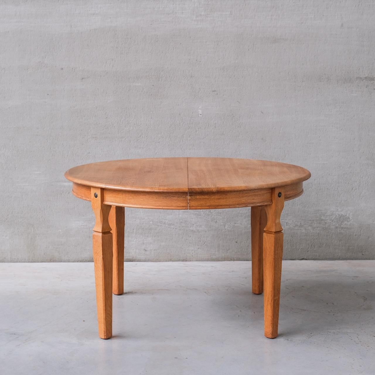 A stylish oak dining table by Henning (Henry) Kjaernulf.

Denmark, c1960s.

One extensions provided which extends to a total of 170 W in cm.

Dimensions below are without the leaves.

Good vintage condition, some scuffs and wear commensurate with