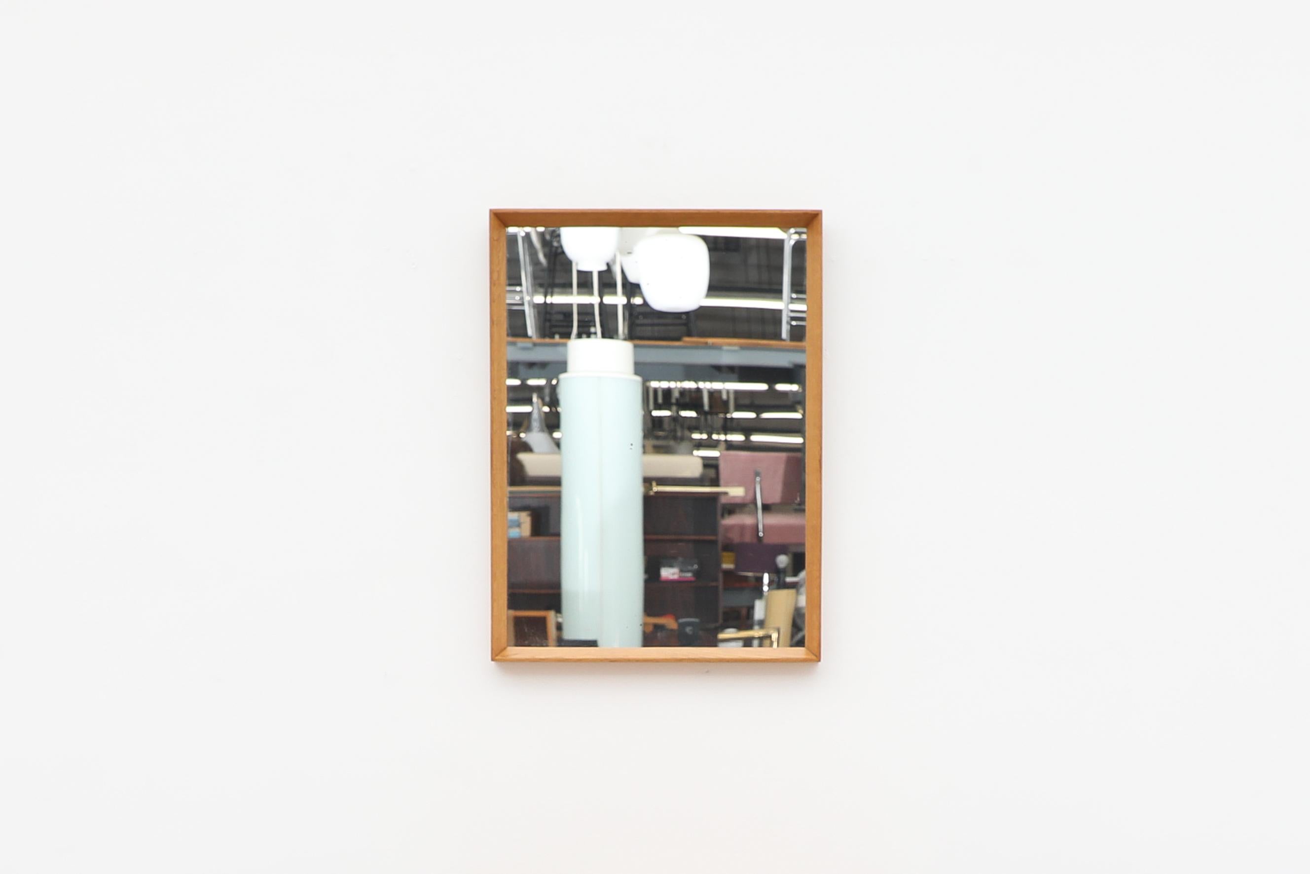 Danish Mid-Century Modern oak square mirror attributed to Aksel Kjersgaard. In original condition with visible wear and patina, consistent with its age and use.