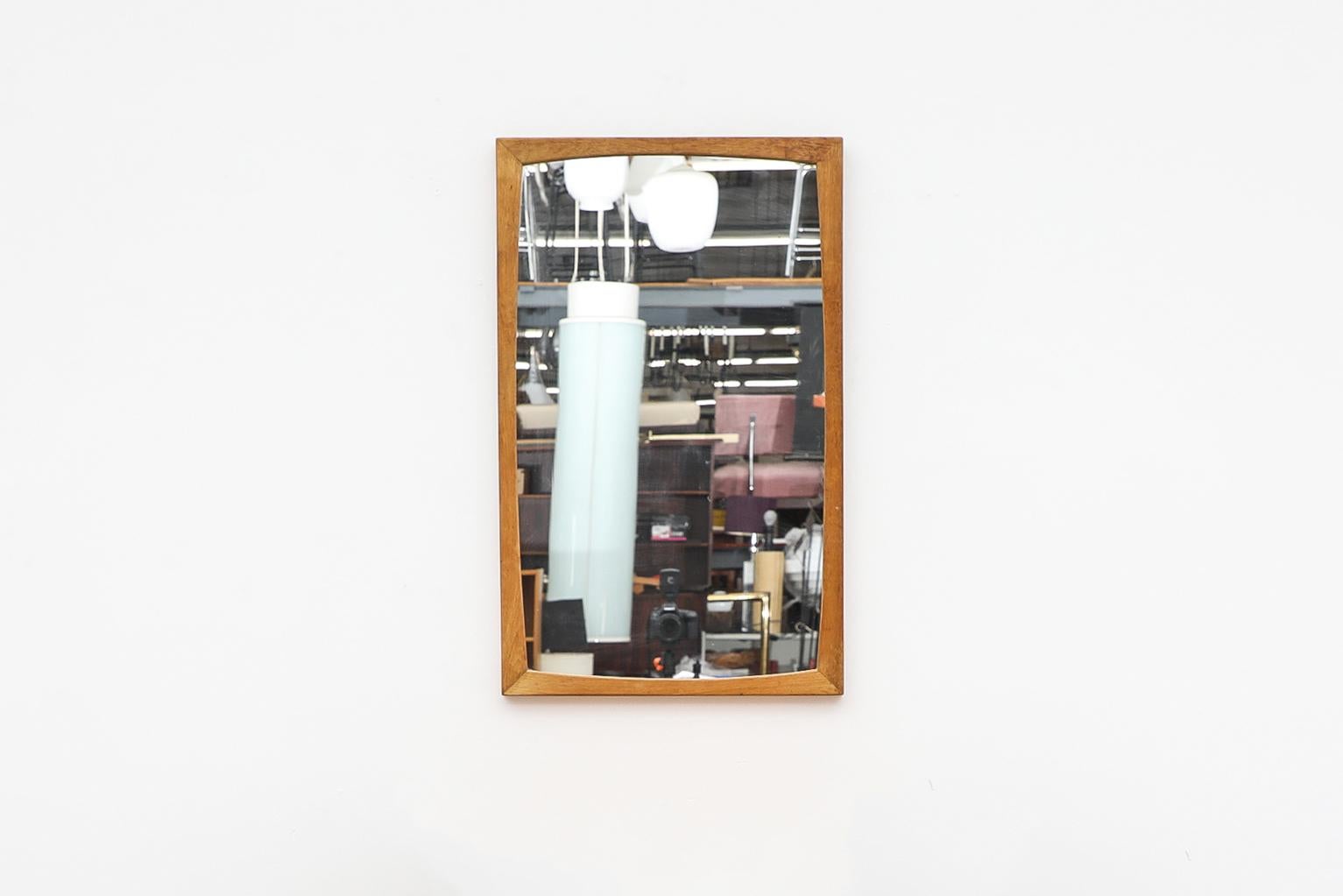 Danish Mid-Century Modern mirror with oak frame. In original condition with visible wear consistent with its age and use.