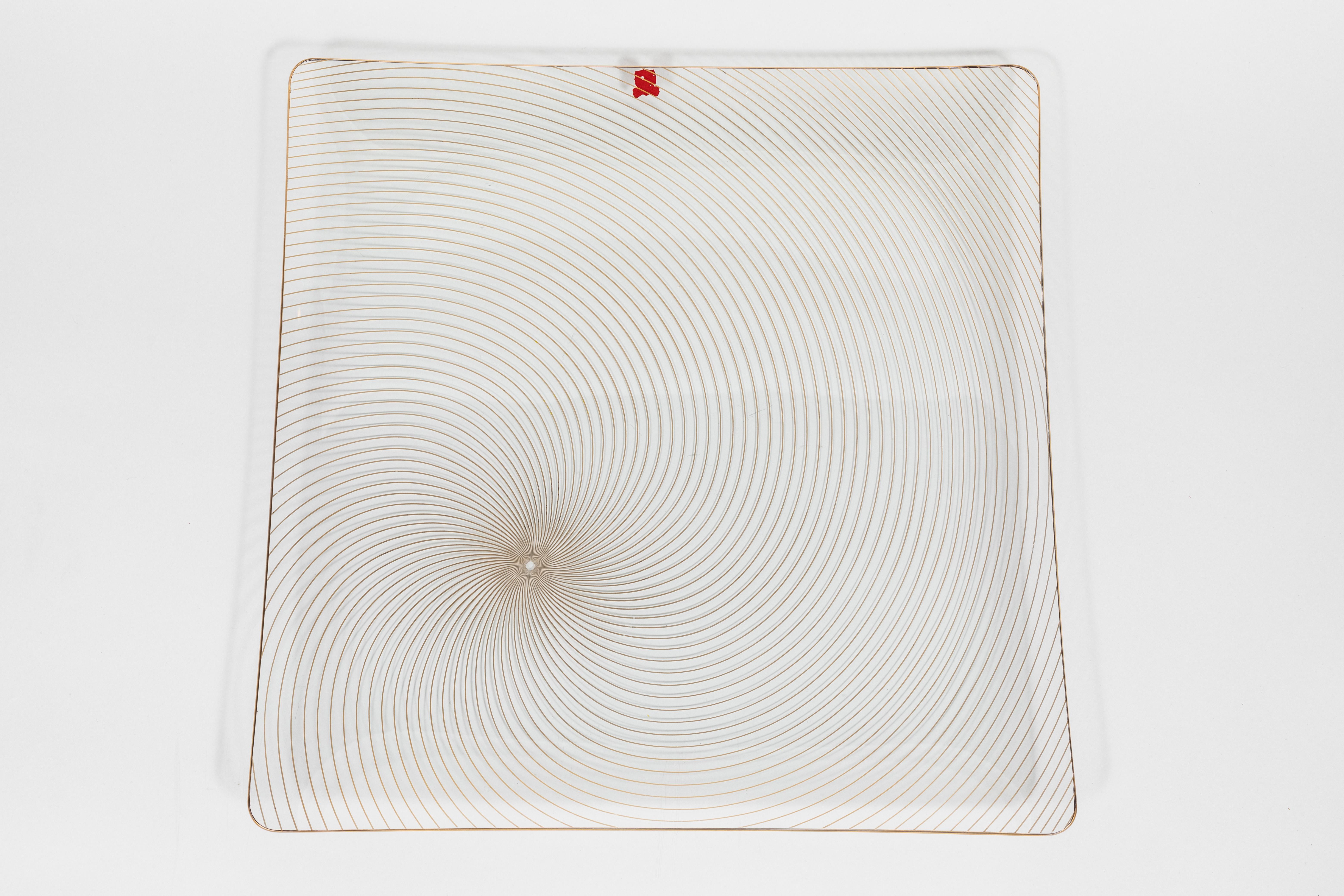 Midcentury Danish Op Art gold swirl platter

This collectible platter features fine bent clear glass and gold lines in a swirl pattern.

Made in the 1960s by MF Crystal & Art Glass MNFC in Denmark.