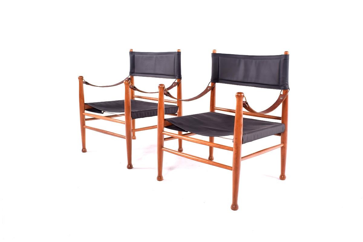Pair of vintage 1960s safari chair, made by Danish manufacturer Farstrup stole. The chair is made of wood, with leather new upholstery and Leather armrest.