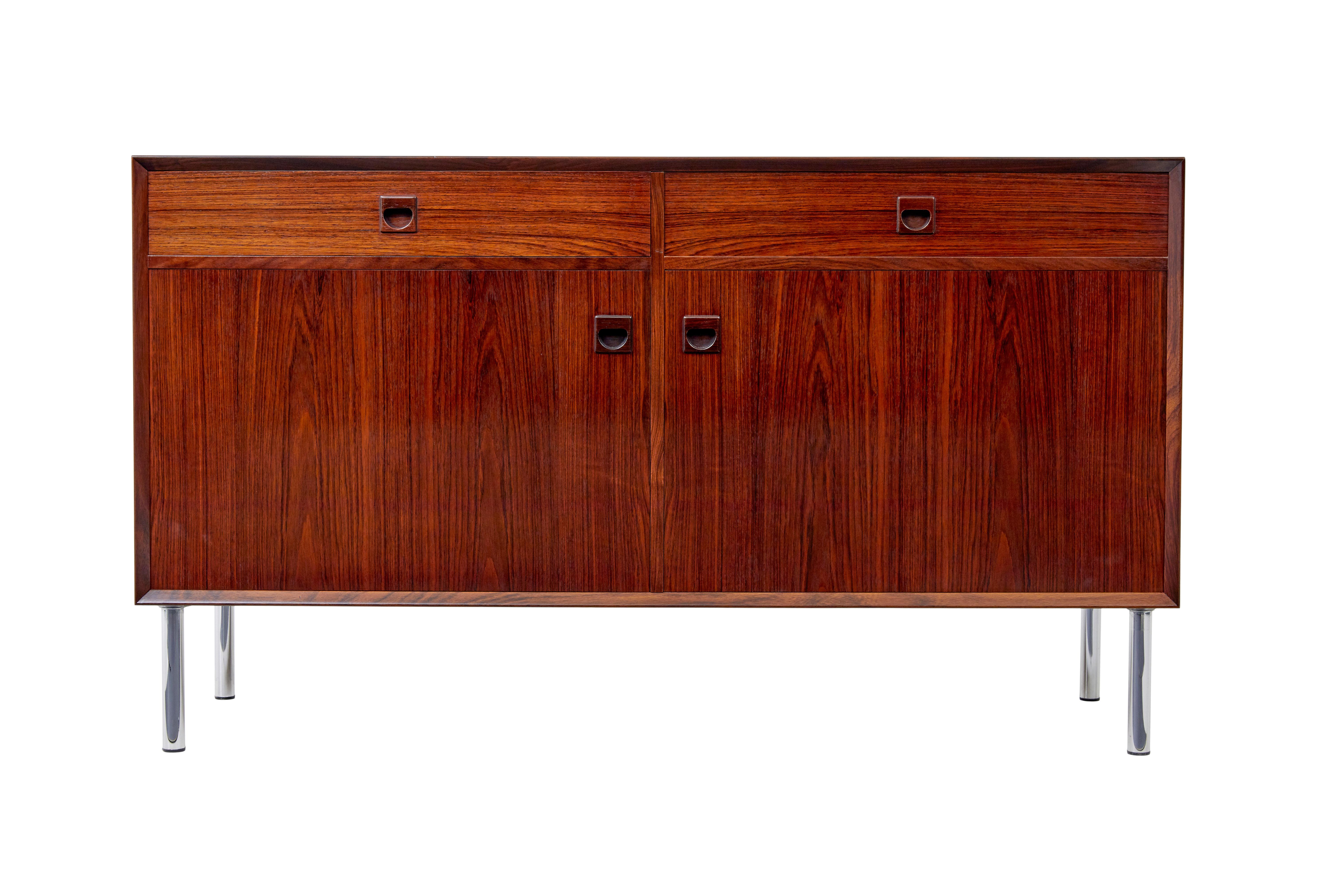 Mid century Danish Palisander buffet sideboard circa 1960.

Good quality palisander veneers used on this sideboard. 2 drawers below the top surface with solid inset handles. Double door cabinet below opens to interior which would have housed 2