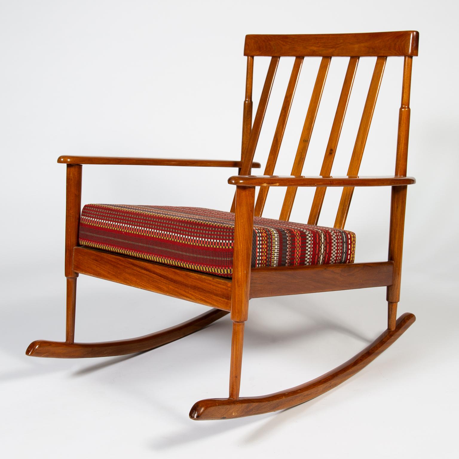 Solid teak frame rocking chair, with newly made square seat cushion upholstered in 'Brick & Greige' point fabric designed by Paul Smith for Maharam.