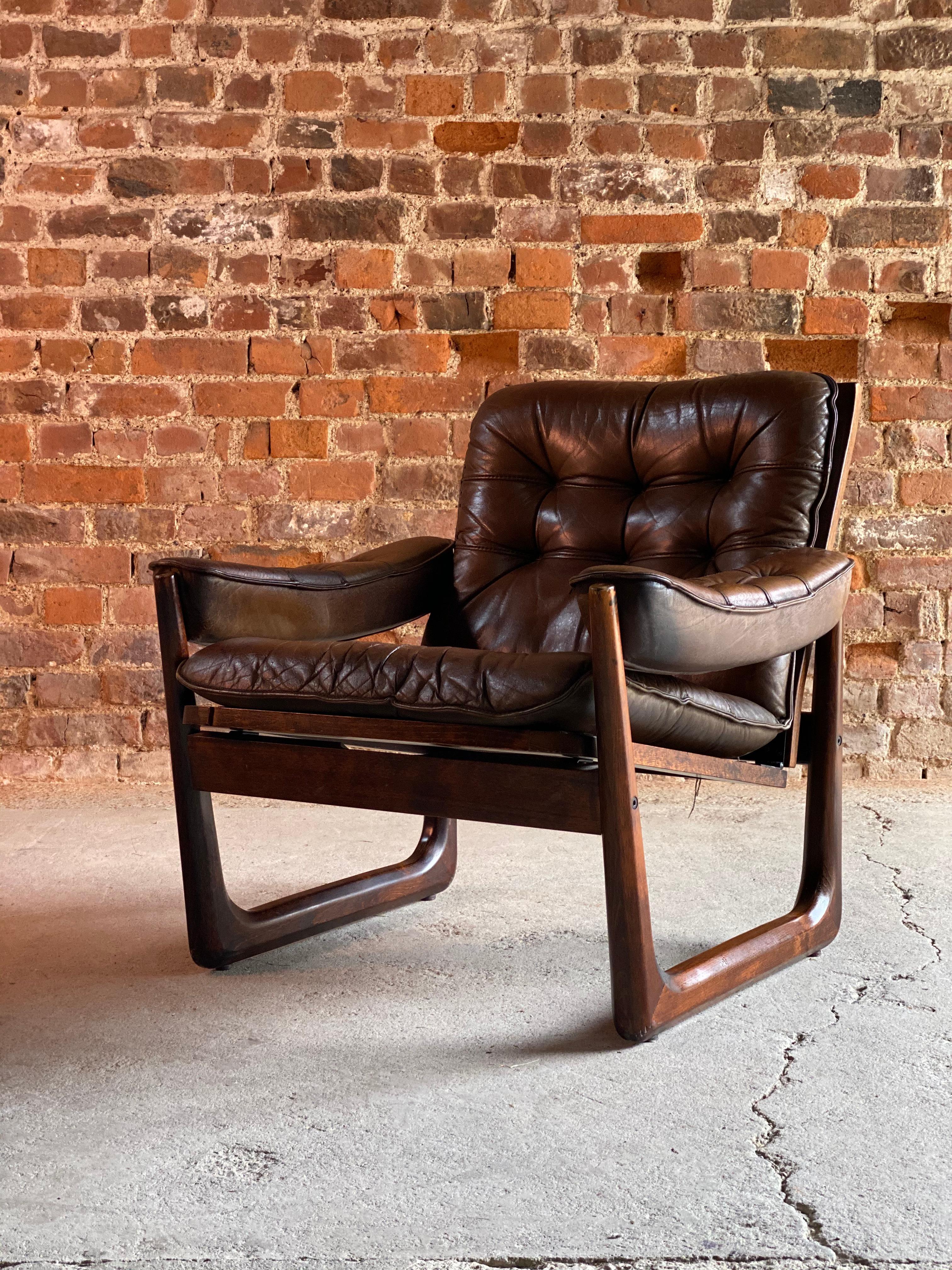 Midcentury Danish rosewood armchair with sled base rosewood circa 1970

Classic midcentury Danish design rosewood armchair circa 1970, the chair features deep soft brown tufted leather seat cushions and armrests on a rosewood sled base frame,