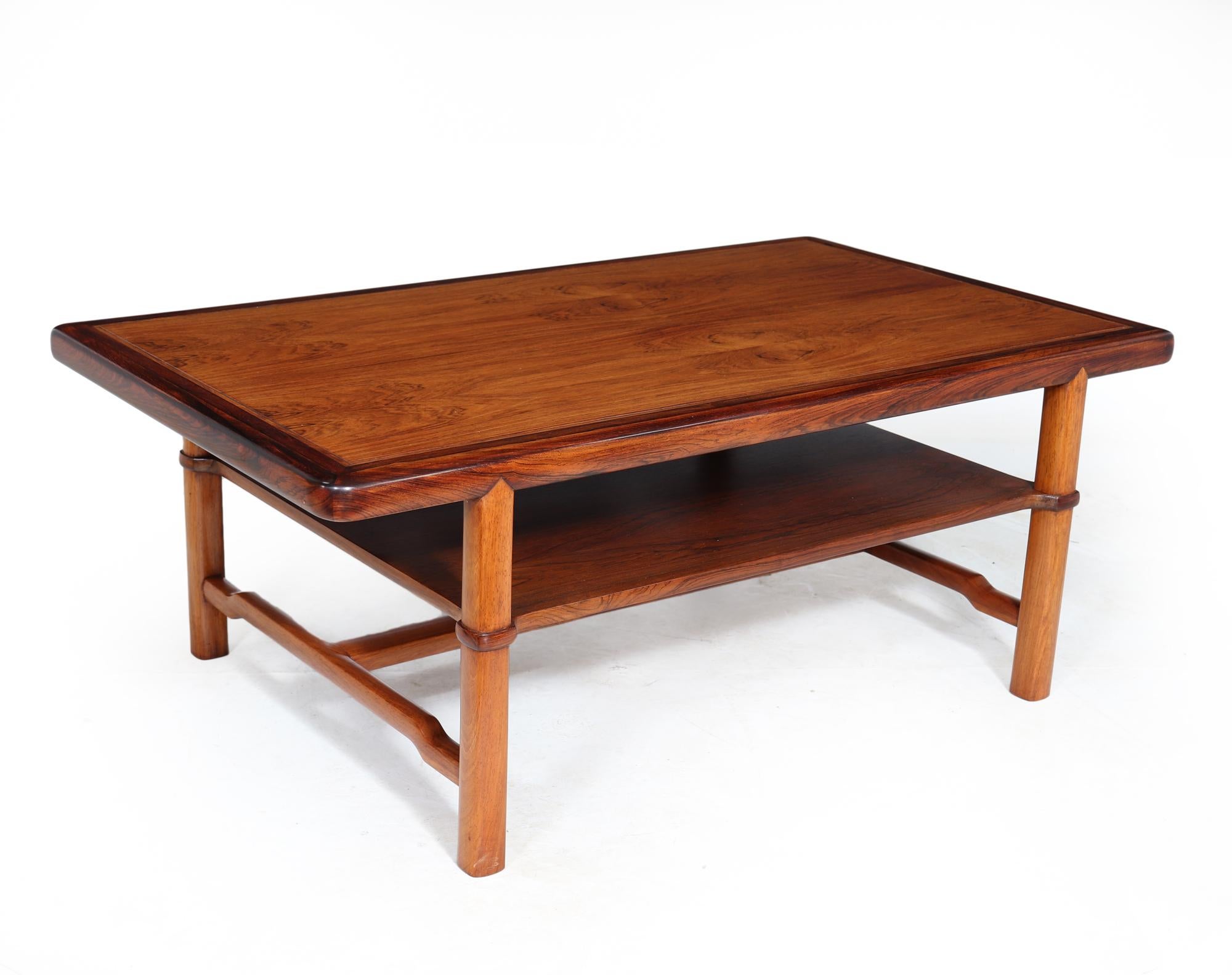 Midcentury DANISH COFFEE TABLE
This Danish coffee table from the 1960s boasts exceptional craftsmanship, designed and produced by Lysberg Hansen & Therp with intricate details such as an inset groove on the top and jointed protrusion on the legs.