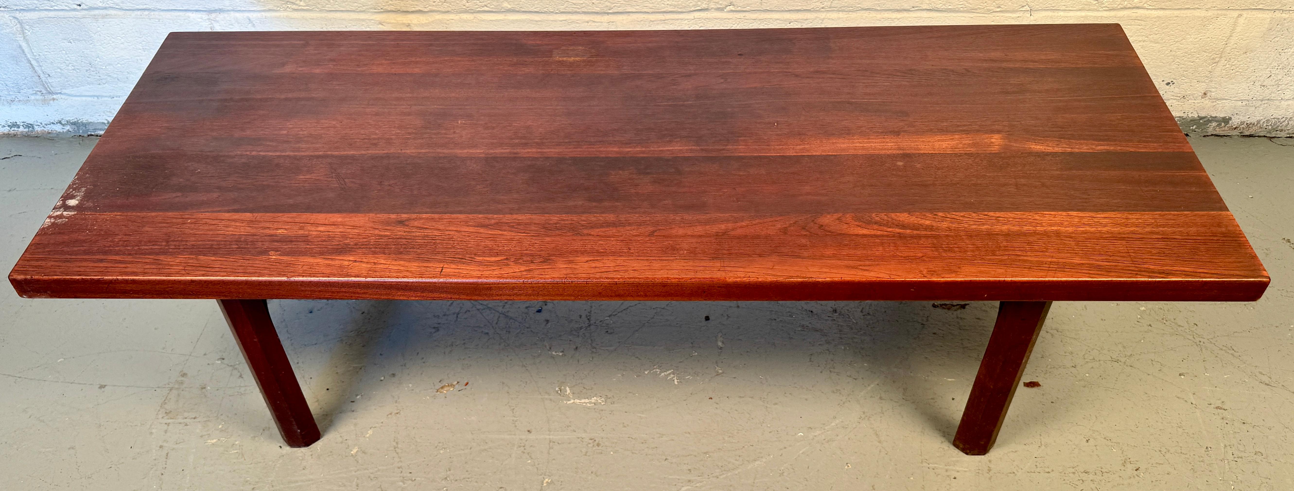 Strikingly elegant and timeless in form, this Mid-Century Danish Rosewood Coffee Table is a sophisticated example of Scandinavian design at its finest. Attributed to celebrated Danish designer Illum Wikkelsø, the table features a minimalist