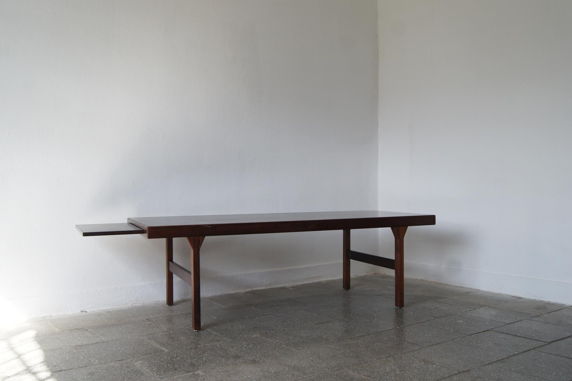 A celebration of the sophisticated and beautifully refined design of the rosewood folding table carved by Dyrlund in the 1960s.
The furniture has a hidden extension, tray in black shade
fits perfectly under the table top.

This is a mastery of