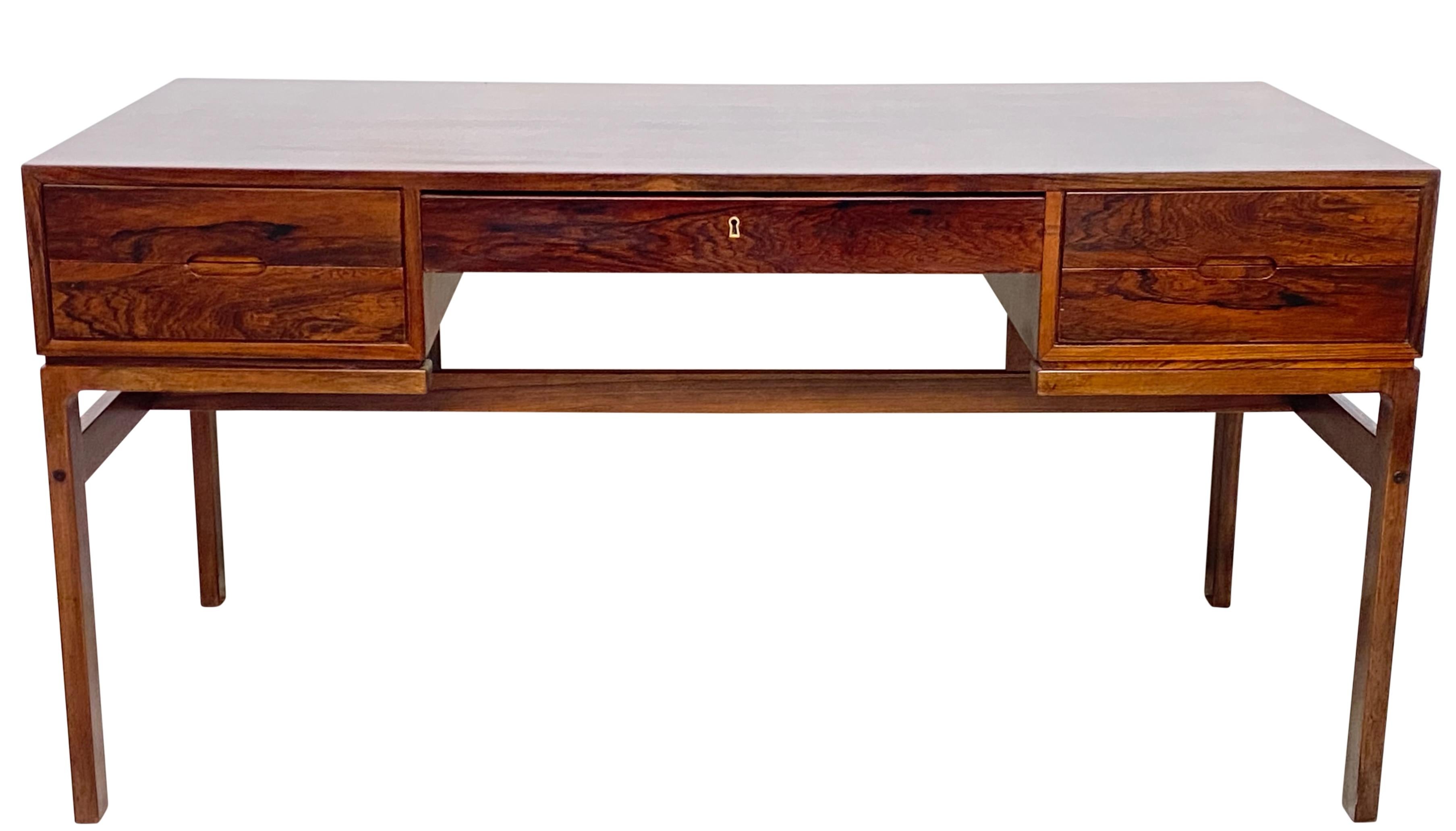 Model No. 80 rosewood desk, designed by Arne Wahl Iversen and produced by Vinde Møbelfabrik in Denmark. It is finished on both sides, with display cubbies on the back, so it can float anywhere in the room.
Highly figural rosewood with original