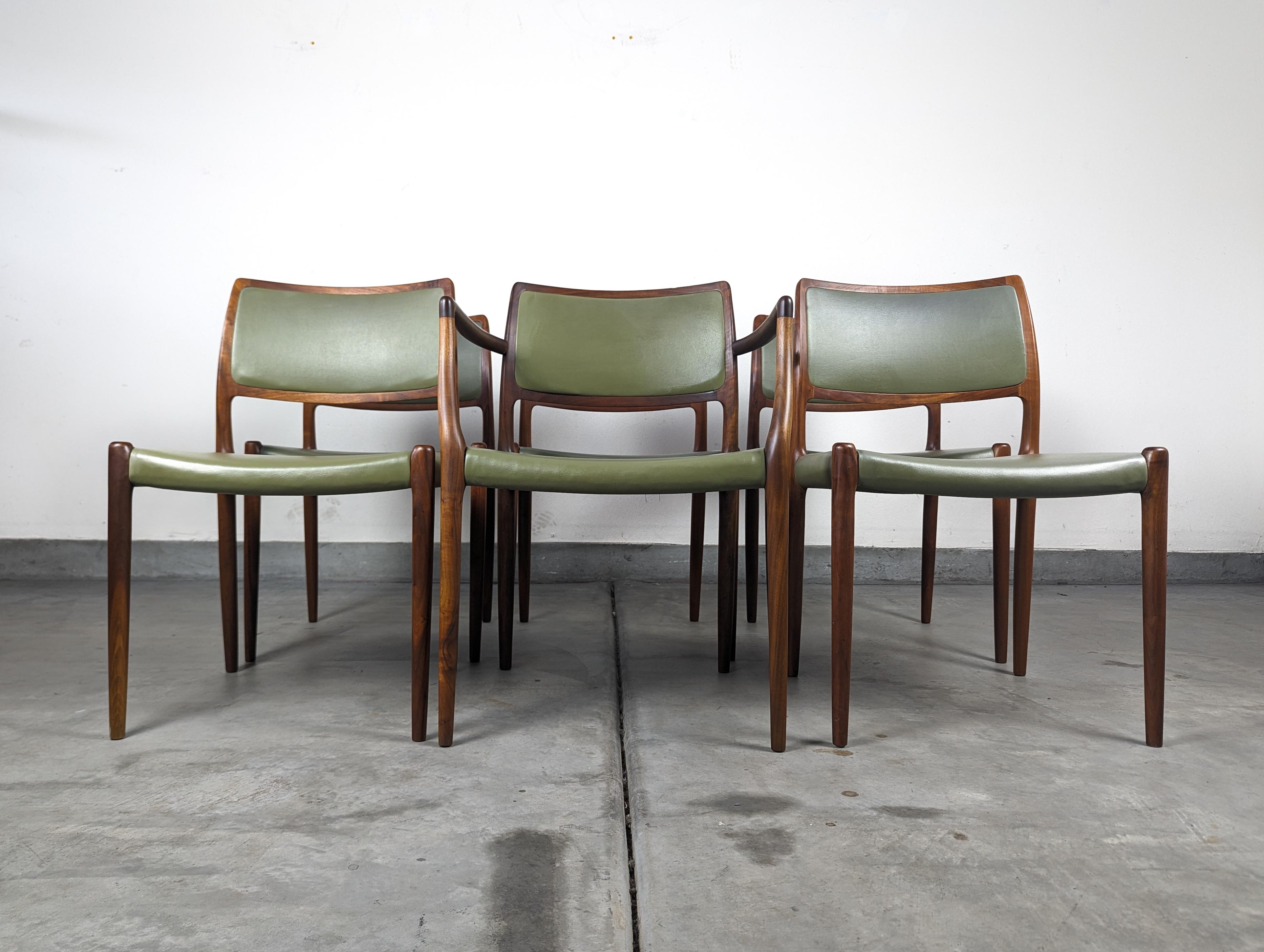 Introducing a timeless treasure for your dining space – a set of six vintage mid-century Danish modern dining chairs designed by the legendary Niels Otto Møller for J.L. Møller. These Model 80 chairs, originating from 1960s Denmark, boast an