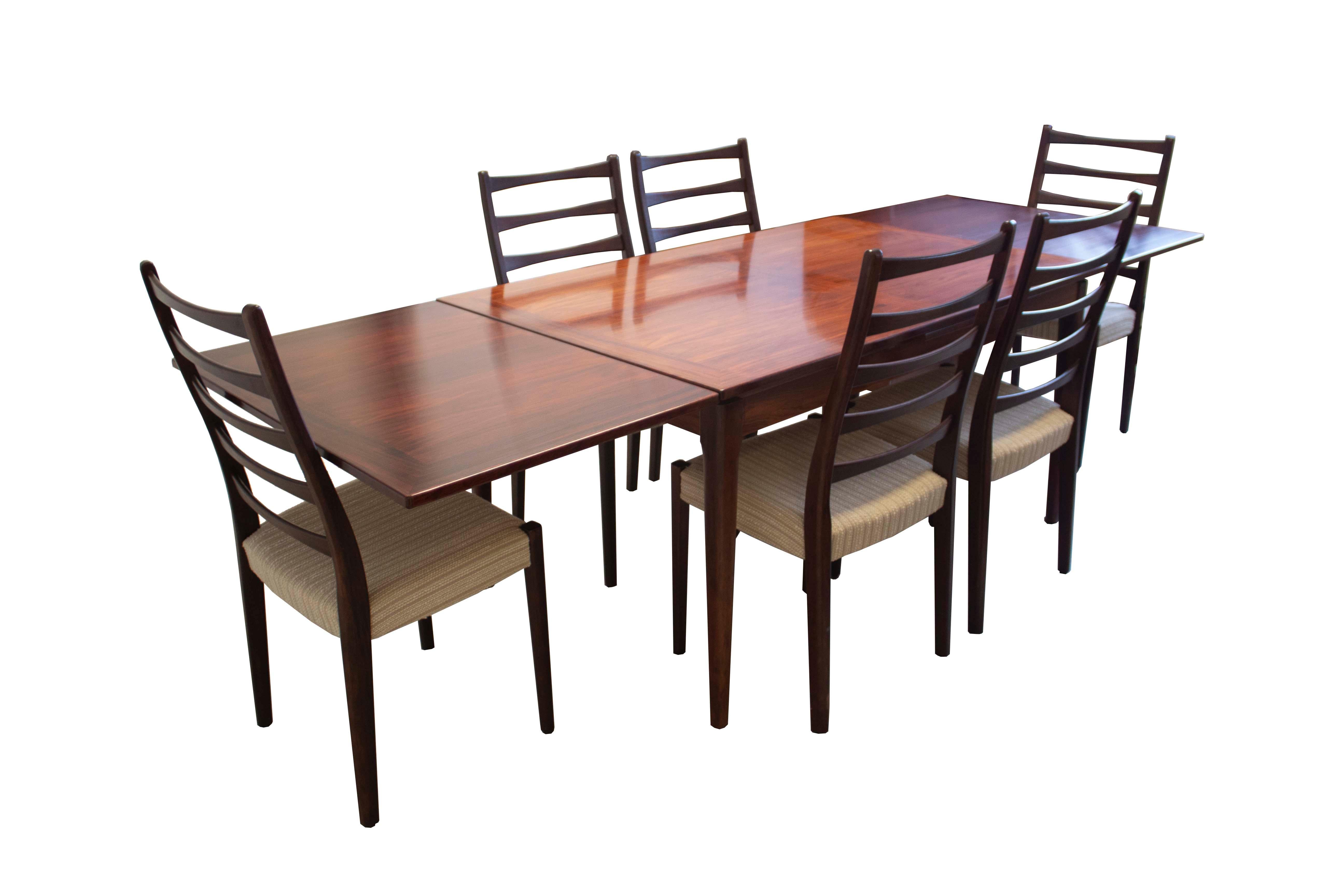Stunning set of six dining chairs and rosewood table with two (2) self-storing leaves by Svegards Markaryd, circa 1970's. The clean modern lines will work well with most aesthetics as well as the neutral creme boucle upholstery. The finish shows