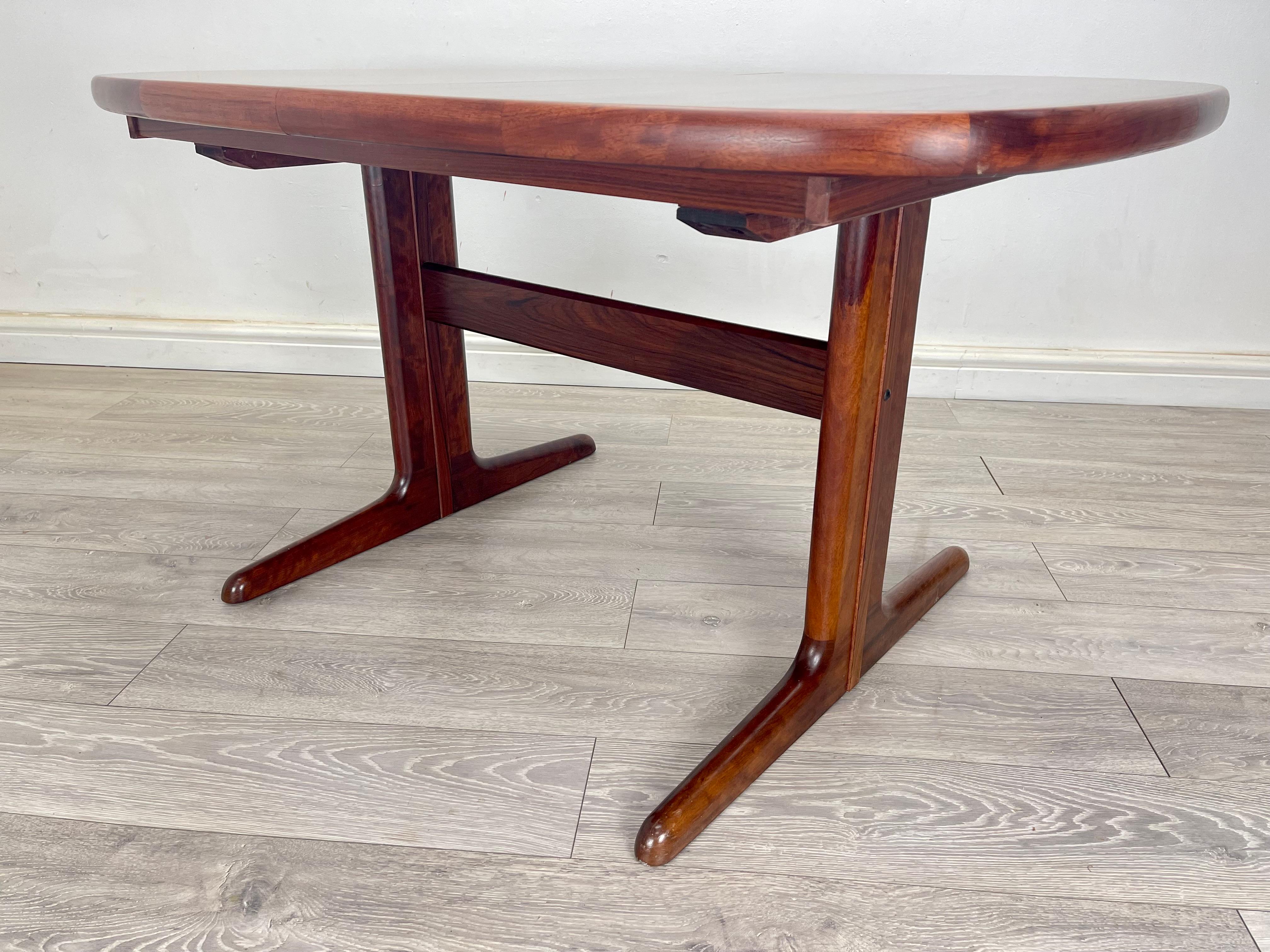 DINING TABLE 
Midcentury Danish rosewood oval extendable dining table made by Skovby, circa 1960. The table has stunning rosewood grain throughout, there’s two extension leaf which neatly store underneath the table. 

DIMENSION 
Height- 72 cm