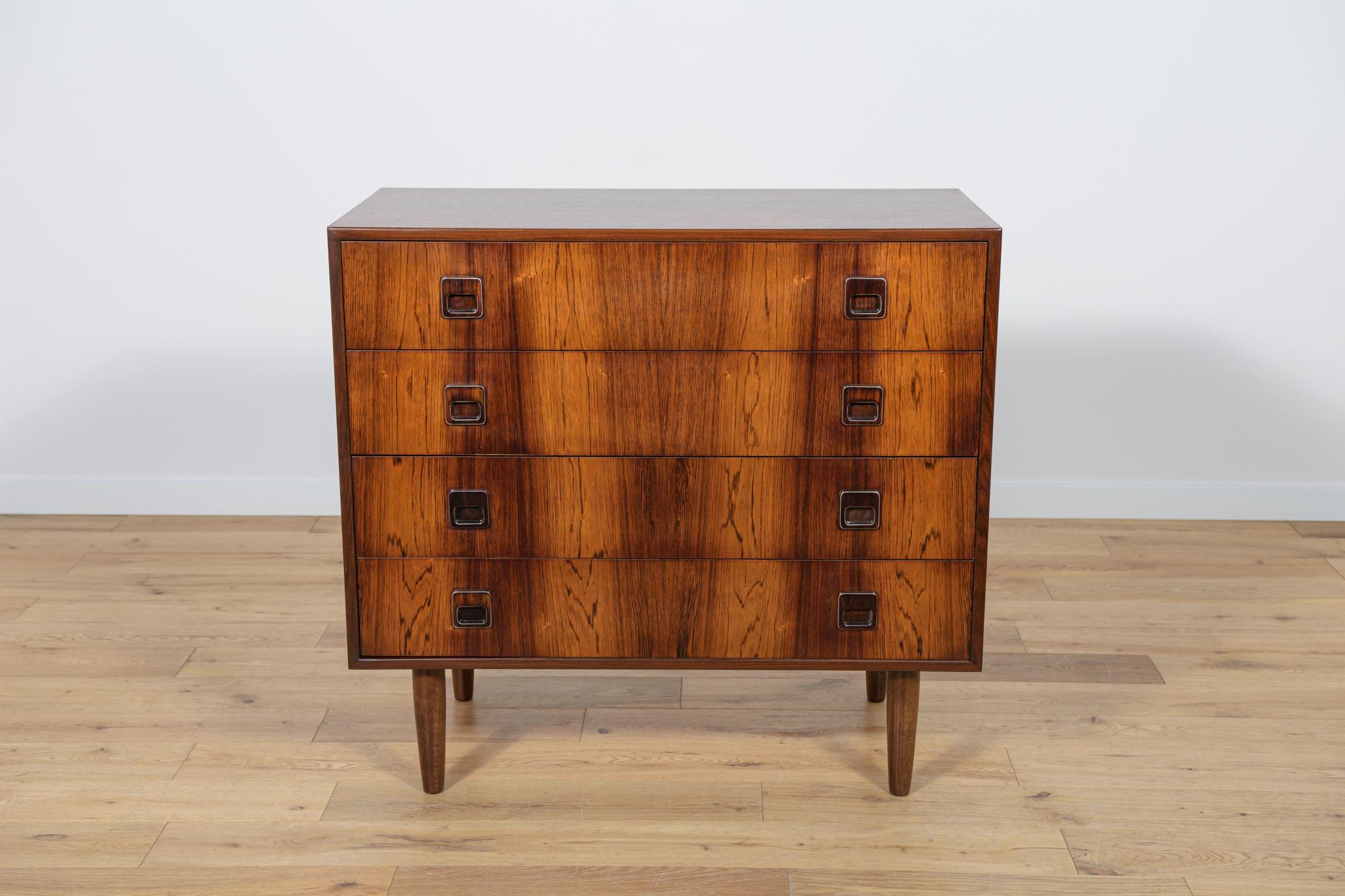 Mid-Century rosewood dresser made during the 1960s in the Denmark. The dresser has profiled handles with a metal accent. The dresser consists of 4 drawers.
The dresser has been cleaned with old surface and finished with guality Danish Oil.