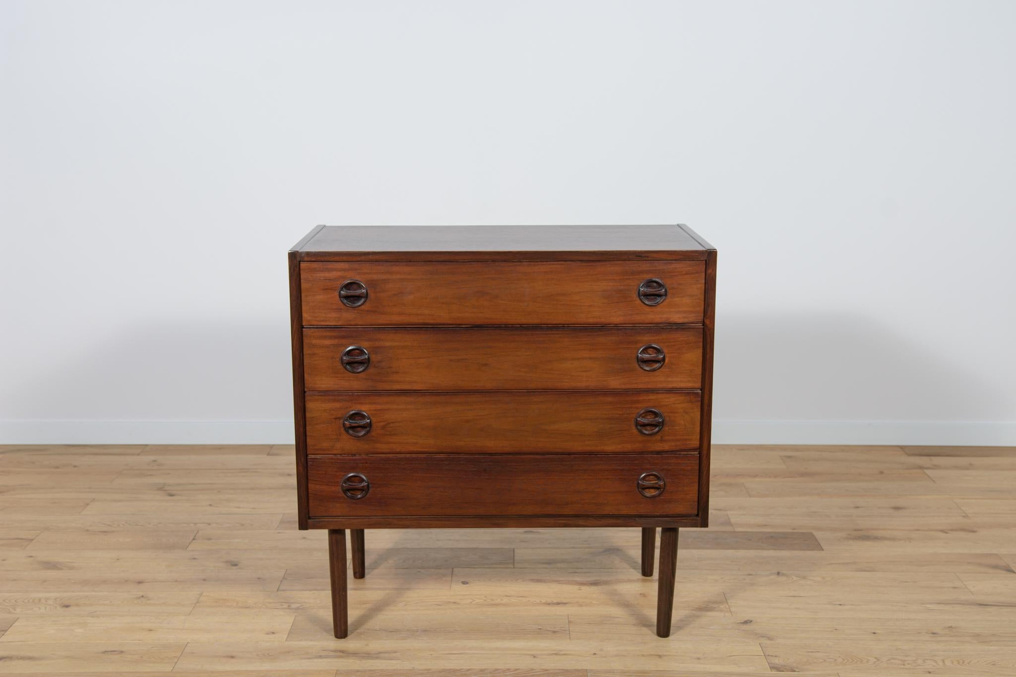 Mid-Century rosewood dresser made during the 1970s in the Denmark. The dresser with an extraordinary design, made with attention to every detail, has profiled handles and edges, adding elegance to it. The dresser consists of 4 drawers.
The dresser