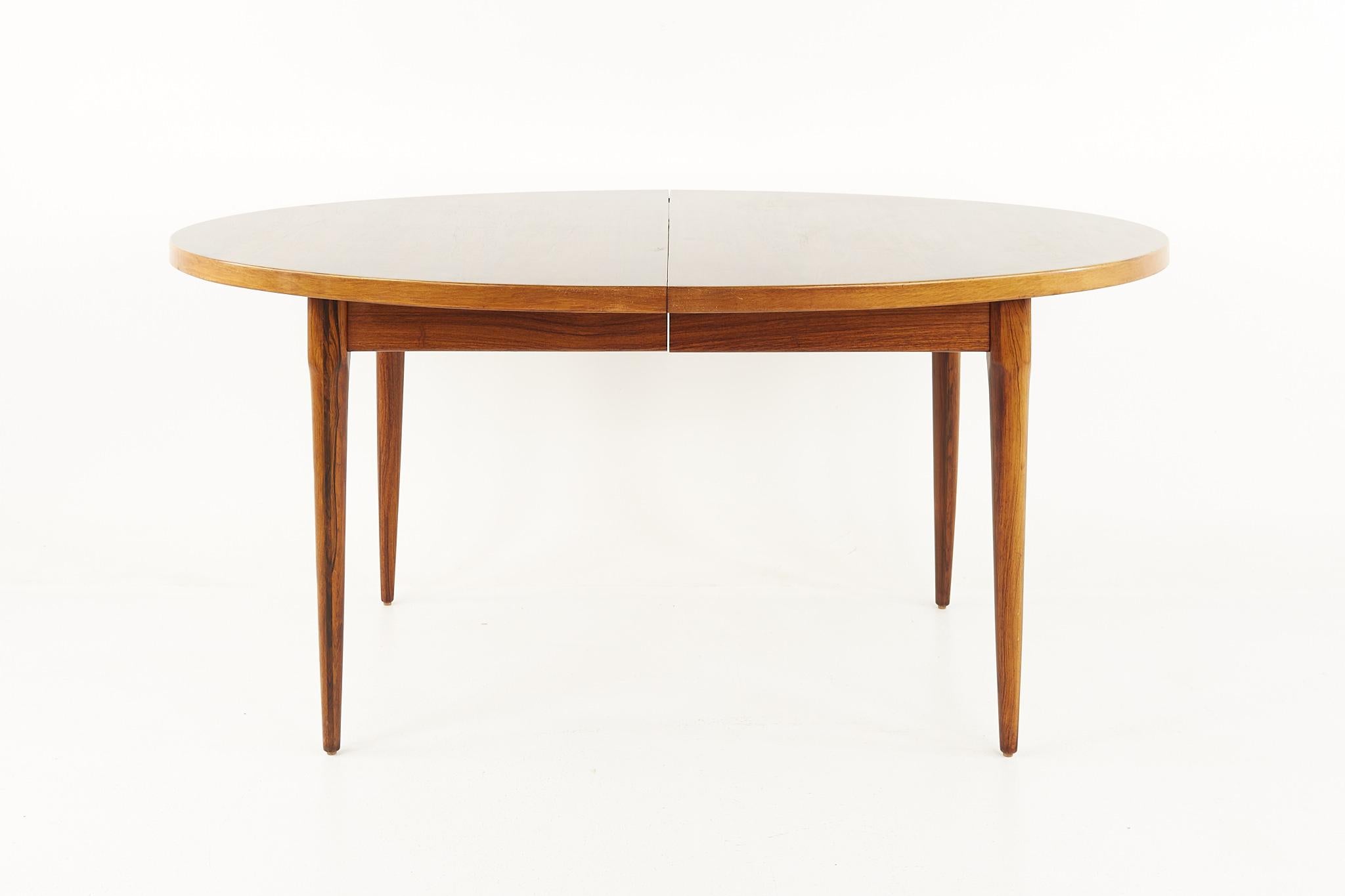 Mid-Century Danish rosewood expanding dining table

This table measures: 64 wide x 42.75 deep x 28.75 inches high, with a chair clearance of 24 inches, each of the 3 leaves are 12 inches wide, making a maximum table width of 100 inches

All