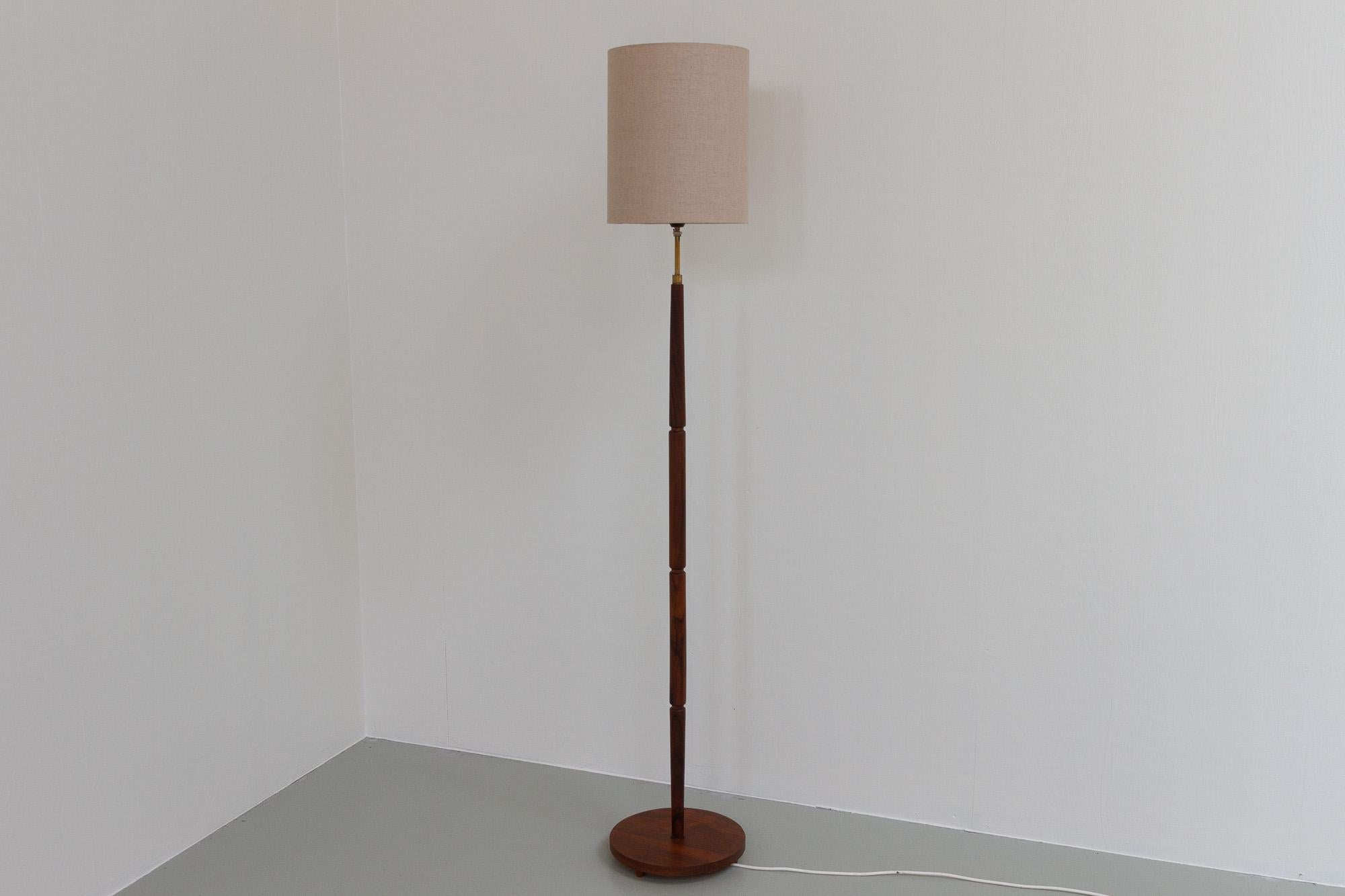 Midcentury Danish Rosewood Floor Lamp, 1960s. 
Beautiful and stylish Scandinavian Modern floor lamp in Rosewood/Palisander and brass made in Denmark in the 1960s. 
Stem with four round pieces of solid Rosewood, top and bottom pieces are slightly