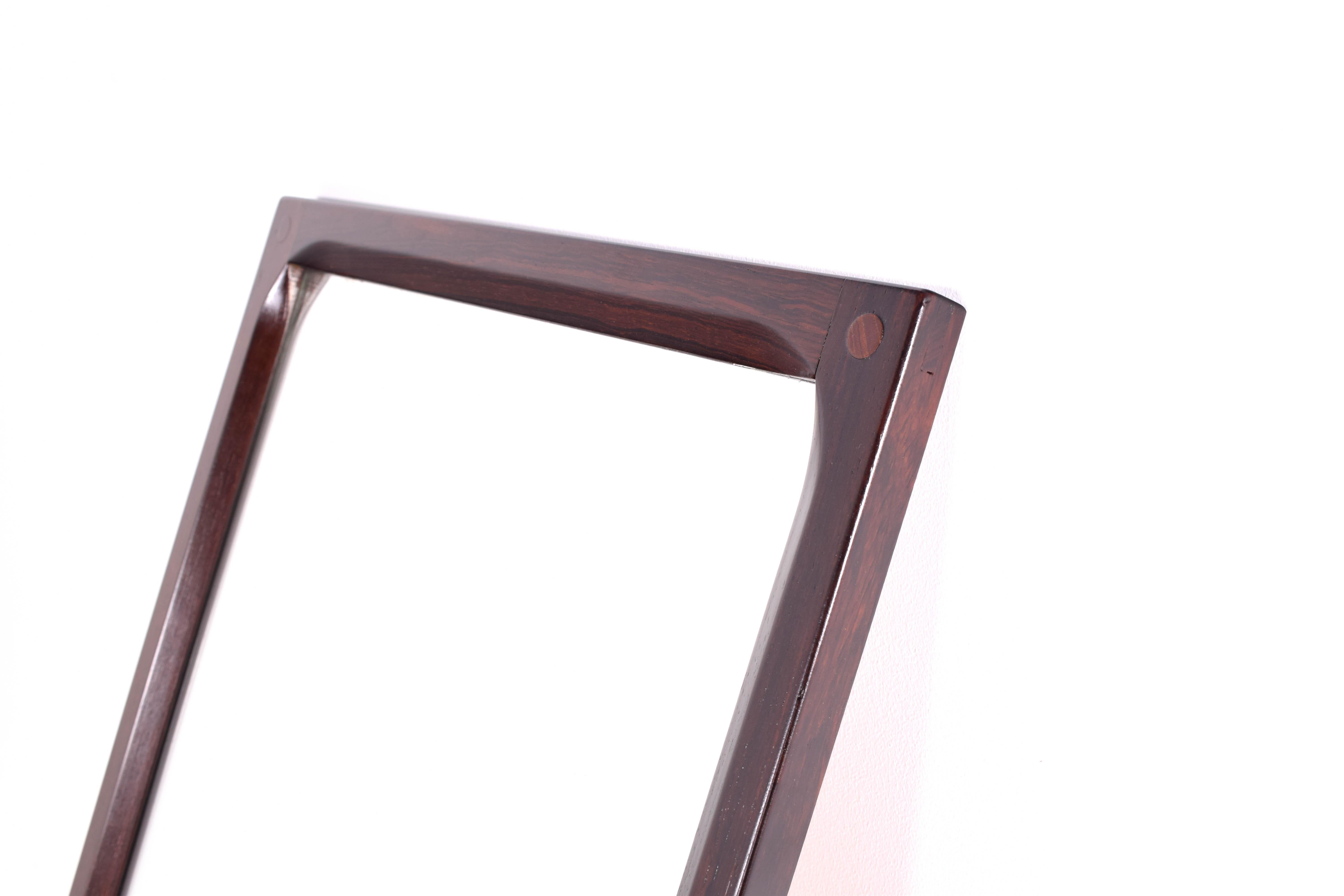 Excellent example of the Classic Scandinavian mirror in rosewood. Versatile design that will work in any room. Mirror is in excellent condition.