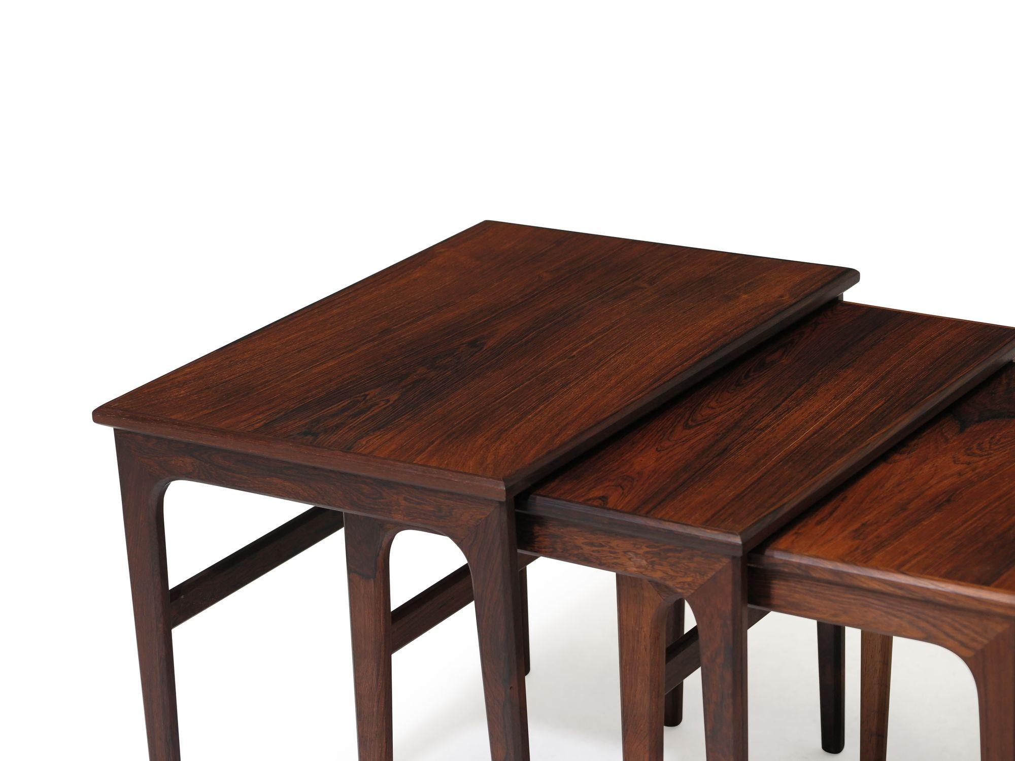 Set of three rosewood nesting tables with tapered legs and minimal design. Flexible in any configuration to suit your needs. 
Measurements 
W 22.75 x D 15.88 x H 18.12
Medium Table
W 20.3/8 x D 14.75 x 17.5/8
Small Table
W 18 x D 13.75 x H