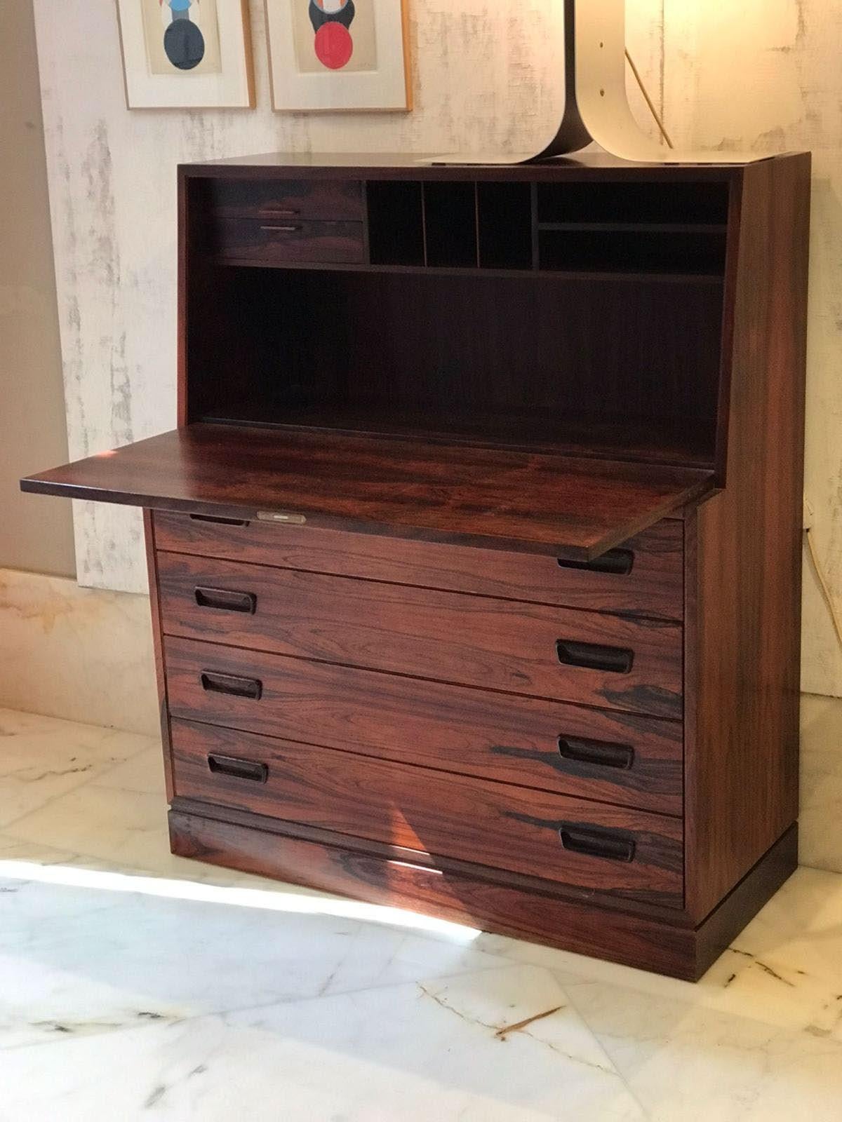 Unveil the elegance and functionality of mid-century Danish design with this exceptional rosewood secretaire, circa 1960s. This versatile piece, meticulously crafted from rich rosewood, seamlessly blends storage and style, making it a coveted