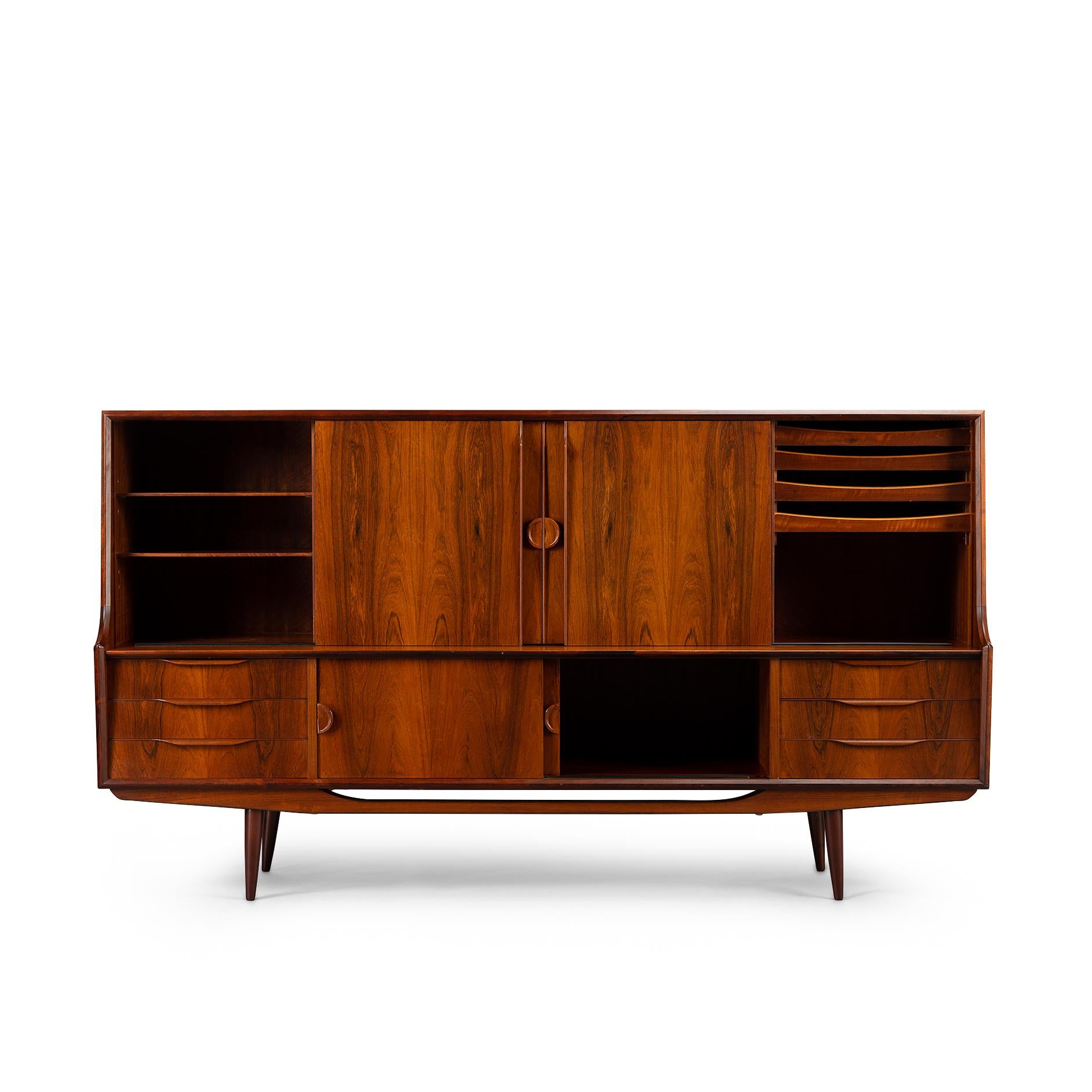Listen up! This sideboard tickles all your senses. Most pronounced are the grips, ear shape cut out of solid rosewood. The sideboard cut from rosewood veneer stands wide legged ready to go and firm on its beautifully crafted base. Further detail for
