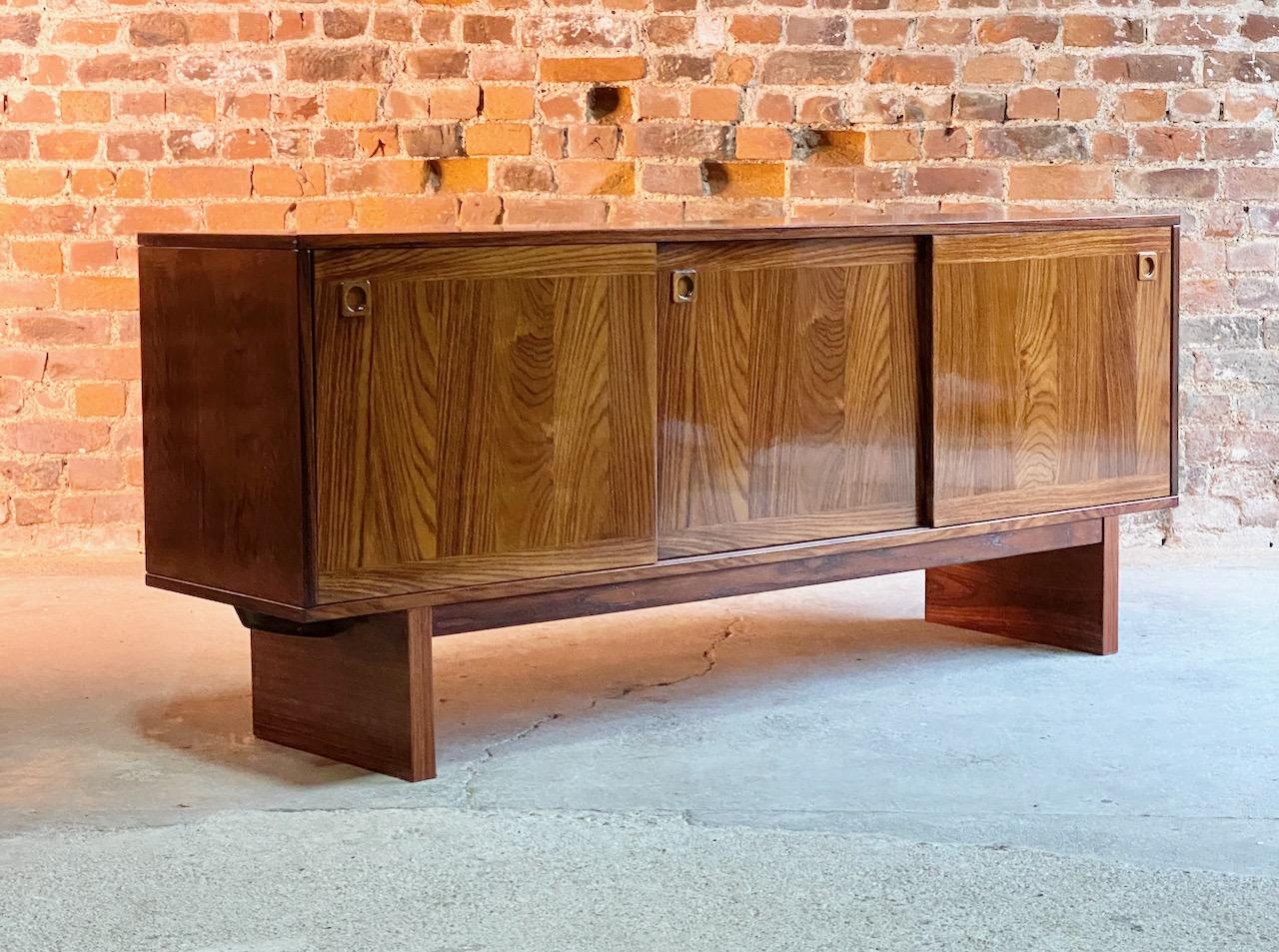 Midcentury Danish rosewood sideboard, Denmark, 1970s

Elegant Mid-Century Modern Danish design Brazilian rosewood sideboard Denmark circa 1970, the rectangular figured top over three sliding doors to the left cupboard two drawers, the middle and